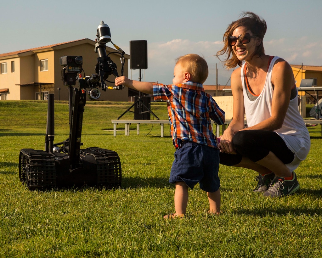 A child gets hands-on with an Explosive Ordnance Disposal robot during the National Night Out event aboard Naval Air Station Sigonella, Italy, Aug. 5, 2014. Marines and Sailors with the second iteration of SP-MAGTF Africa 14 participated in the event with a static display of weapons, an Explosive Ordnance Disposal robot, and two vehicles organic to the Marine Corps. SP-MAGTF Africa continues to build relationships with the community while simultaneously strengthening U.S. Africa Command and U.S. Marine Corps Forces Africa’s ability to assist partner nations in addressing security challenges in the region. (U.S. Marine Corps photo by Cpl. Shawn Valosin)