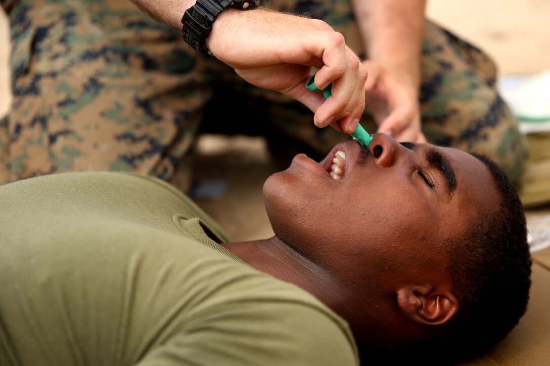 Corporal David Williams, a mortarman with Black Sea Rotational Force 14.2, from 3rd Battalion, 8th Marine Regiment, receives nasogastric intubation during combat lifesaving training as part of exercise Platinum Wolf 14 aboard Borovac Training Area, Serbia, July 7, 2014. This is the first iteration of the Platinum Wolf exercise, hosted by Serbia, with members of the Serbian, Croatian, Bulgarian, Romanian, Azerbaijani, Macedonian and United States militaries participating in the exercise. The exercise focused on non-lethal system training and peacetime operations in order to foster greater interoperability with each other while promoting peace and prosperity in the Black Sea, Balkan and Caucasus regions of Eastern Europe. (Official Marine Corps photo by Lance Cpl. Scott W. Whiting, BSRF PAO/ Released)