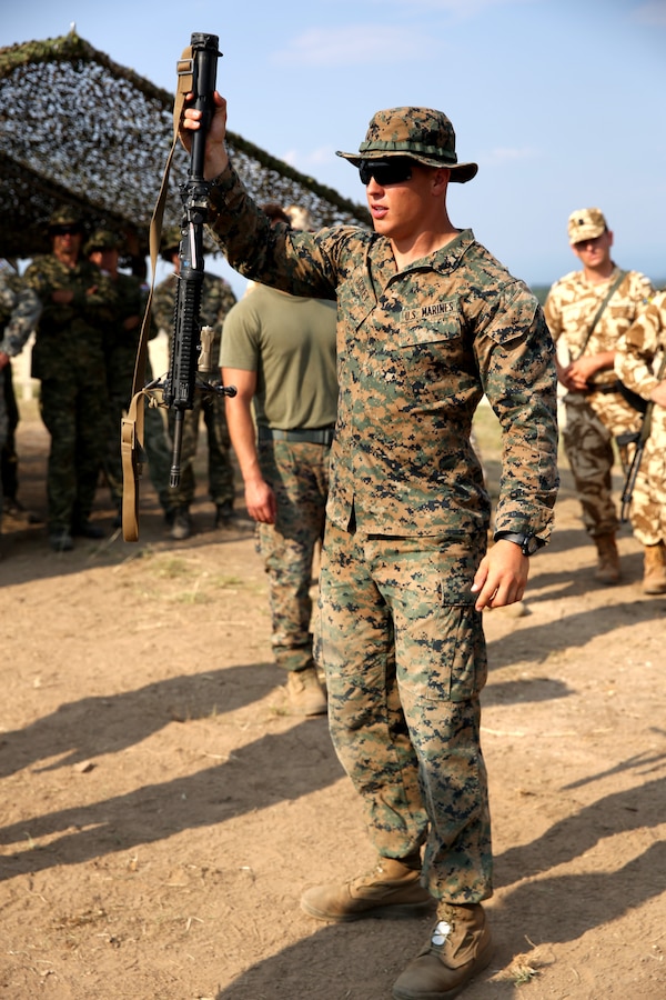 United States Marine Corps Lance Cpl. Zachary Sickey, an infantryman with Black Sea Rotational Force 14.2, from 3rd Battalion, 8th Marine Regiment, shows Romanian and Croatian soldiers an M4 service rifle during exercise Platinum Wolf 14 aboard Borovac Training Area, Serbia, July 7, 2014. Each nation spent the day displaying their weapons and unique patrolling techniques during the training. This is the first iteration of the Platinum Wolf exercise, hosted by Serbia, with members of the Serbian, Croatian, Bulgarian, Romanian, Azerbaijani, Macedonian and United States militaries participating in the exercise. The exercise focused on non-lethal system training and peacetime operations in order to foster greater interoperability with each other while promoting peace and prosperity in the Black Sea, Balkan and Caucasus regions of Eastern Europe. (Official Marine Corps photo by Lance Cpl. Scott W. Whiting, BSRF PAO/ Released)