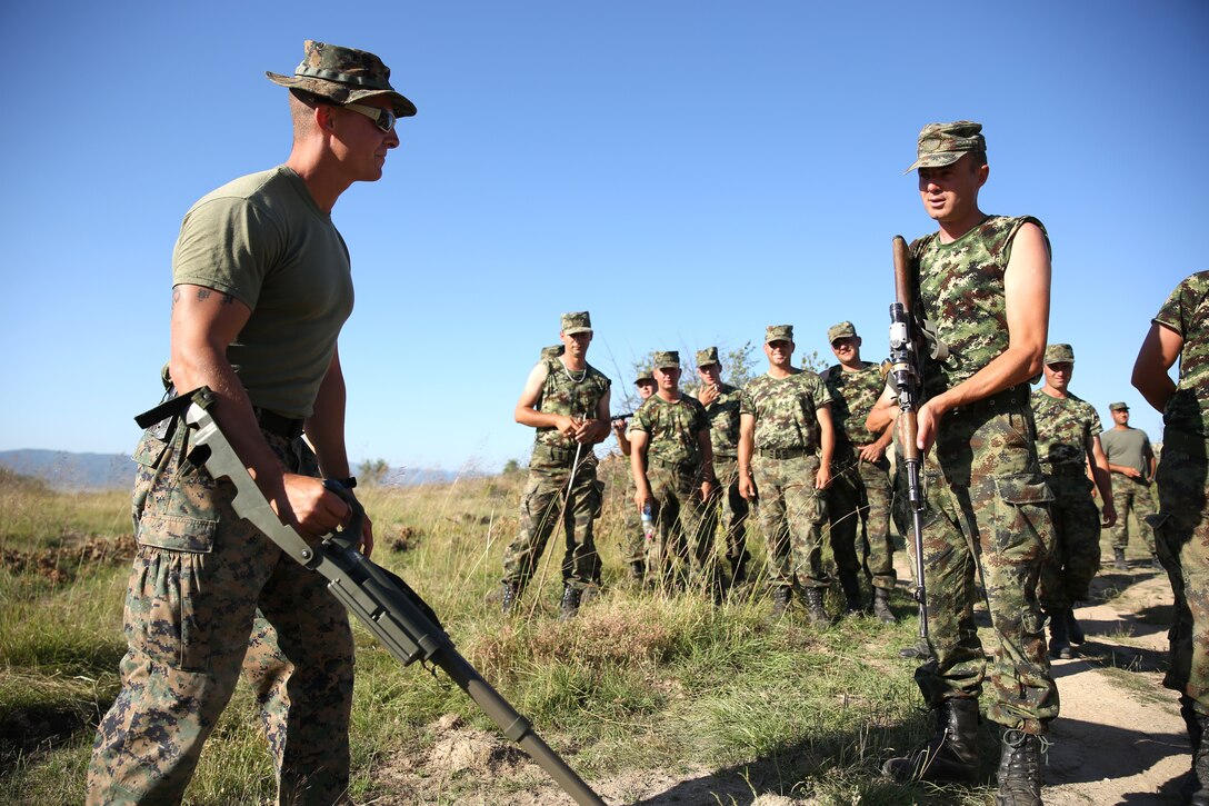 United States Marine Corps Cpl. Brandon Haney, a squad leader with Black Sea Rotational Force 14.2, from 3rd Battalion, 8th Marine Regiment, shows Serbian soldiers how to operate a compact metal detector during improvised explosive device training as part of exercise Platinum Wolf 14 aboard Borovac Training Area, Serbia, July 9, 2014. This is the first iteration of the Platinum Wolf exercise, hosted by Serbia, with members of the Serbian, Croatian, Bulgarian, Romanian, Azerbaijani, Macedonian and United States militaries participating in the exercise. The exercise focused on non-lethal system training and peacetime operations in order to foster greater interoperability with each other while promoting peace and prosperity in the Black Sea, Balkan and Caucasus regions of Eastern Europe. (Official Marine Corps photo by Lance Cpl. Scott W. Whiting, BSRF PAO/ Released)