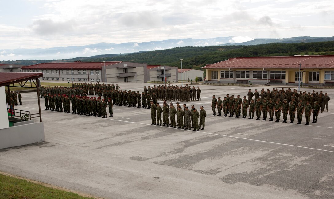 Participants of exercise Platinum Wolf 14 stand in formation during the exercise’s closing ceremony aboard South Base, Serbia, July 11, 2014. This is the first iteration of the Platinum Wolf exercise, hosted by Serbia, with members of the Serbian, Croatian, Bulgarian, Romanian, Azerbaijani, Macedonian and United States militaries participating in the exercise. The exercise focused on non-lethal system training and peacetime operations in order to foster greater interoperability with each other while promoting peace and prosperity in the Black Sea, Balkan and Caucasus regions of Eastern Europe. (Official Marine Corps photo by Lance Cpl. Scott W. Whiting, BSRF PAO/ Released)