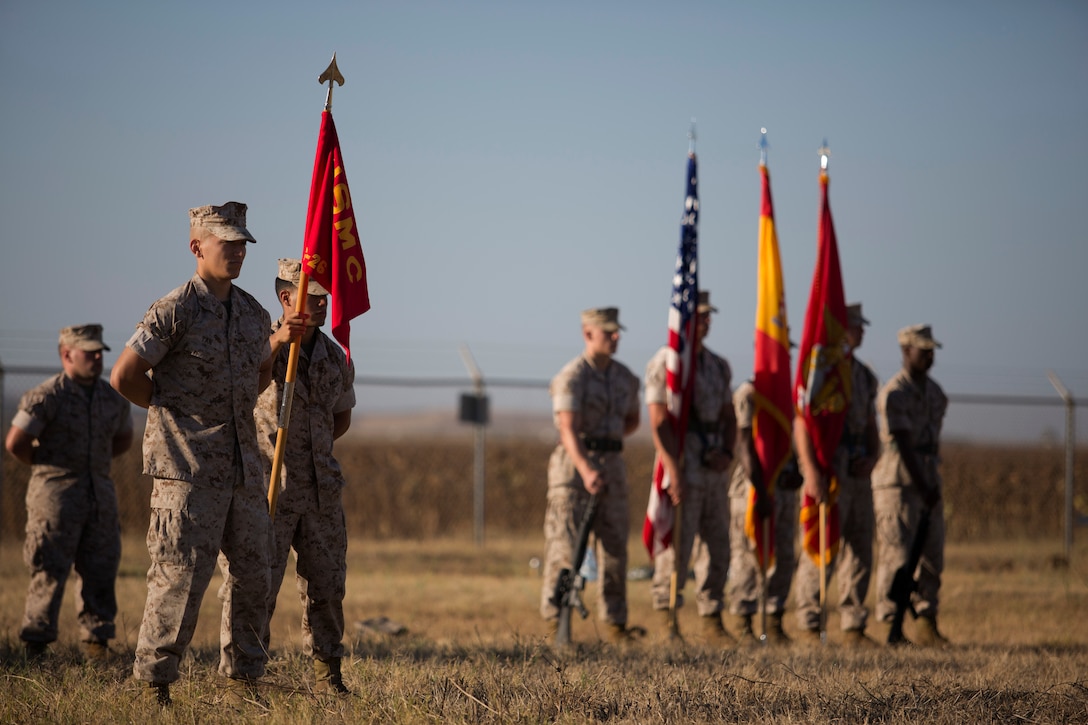 U.S. Marines and Sailors with Special Purpose Marine Air- Ground Task Force Crisis Response (SPMAGTF-CR) stand parade rest in formation during a transfer of authority ceremony aboard Moron Air Base, Spain, Aug 8, 2014. The purpose of the ceremony was to conduct a proper transition of the SPMAGTF-CR command element from 8th Marine Regiment to the 26th Marine Expeditionary Unit. (U.S. Marine Corps photo by Lance Cpl. Andre Dakis, 26th MEU Combat Camera/Released)