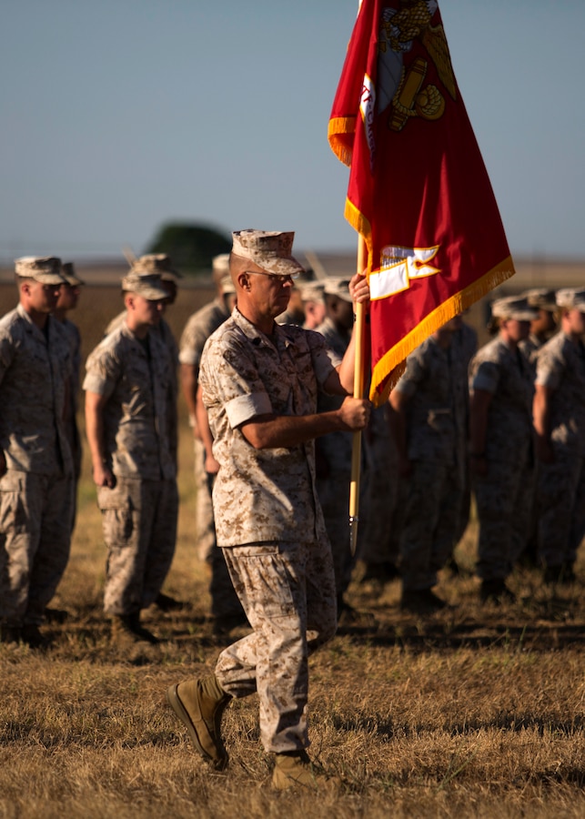 U.S. Marine Corps Sgt. Maj. George Rabidou Special Purpose Marine Air- Ground Task Force Crisis Response (SPMAGTF-CR) sergeant major carries the command flag during the SPMAGTF-CR transfer of authority ceremony aboard Moron Air Base, Spain, Aug 8, 2014. The purpose of the ceremony was to conduct a proper transition of the SPMAGTF-CR command element from 8th Marine Regiment to the 26th Marine Expeditionary Unit. (U.S. Marine Corps photo by Lance Cpl. Andre Dakis, 26th MEU Combat Camera/Released)