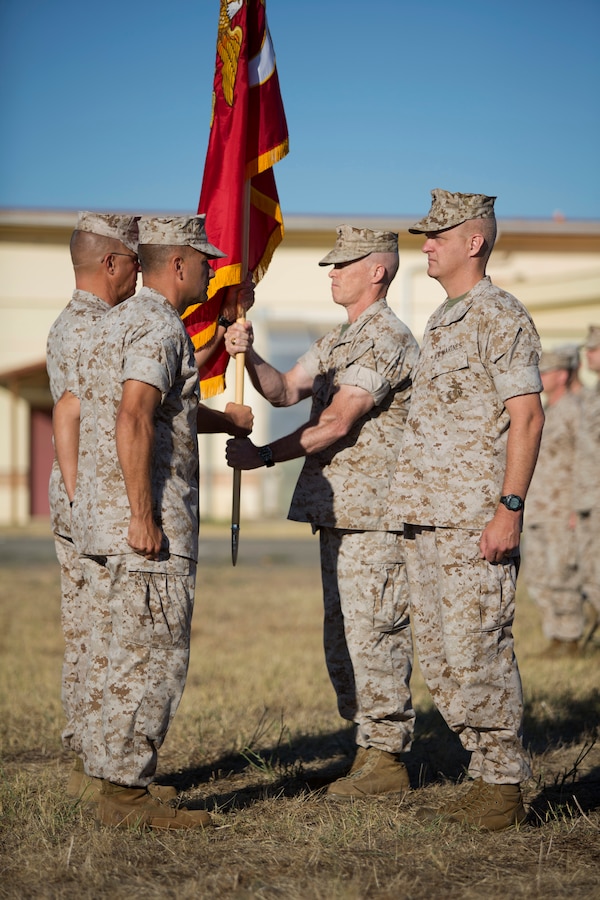 U.S. Marine Corps Sgt. Maj. George Rabidou Special Purpose Marine Air- Ground Task Force Crisis Response (SPMAGTF-CR) sergeant major hands the command flag to commanding officer Col. Kenneth Detreux during the SPMAGTF-CR transfer of authority ceremony aboard Moron Air Base, Spain, Aug 8, 2014. The purpose of the ceremony was to conduct a proper transition of the SPMAGTF-CR command element from 8th Marine Regiment to the 26th Marine Expeditionary Unit. (U.S. Marine Corps photo by Lance Cpl. Andre Dakis, 26th MEU Combat Camera/Released)