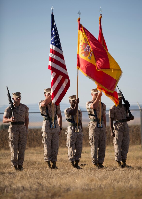 U.S. Marines with the Special Purpose Marine Air- Ground Task Force Crisis Response (SPMAGTF-CR) color guard hold the U.S., Spanish, and Marine Corps flags during the playing of the national anthems of Spain and the U.S. during the SPMAGTF-CR transfer of authority ceremony aboard Moron Air Base, Spain, Aug 8, 2014. The purpose of the ceremony was to conduct a proper transition of the SPMAGTF-CR command element from 8th Marine Regiment to the 26th Marine Expeditionary Unit. (U.S. Marine Corps photo by Lance Cpl. Andre Dakis, 26th MEU Combat Camera/Released)