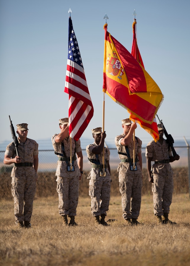 U.S. Marines with the Special Purpose Marine Air- Ground Task Force Crisis Response (SPMAGTF-CR) color guard hold the U.S., Spanish, and Marine Corps flags during the playing of the national anthems of Spain and the U.S. during the SPMAGTF-CR transfer of authority ceremony aboard Moron Air Base, Spain, Aug 8, 2014. The purpose of the ceremony was to conduct a proper transition of the SPMAGTF-CR command element from 8th Marine Regiment to the 26th Marine Expeditionary Unit. (U.S. Marine Corps photo by Lance Cpl. Andre Dakis, 26th MEU Combat Camera/Released)