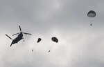 A group of German paratroopers jumps from a CH-47 Chinook helicopter during Leapfest Airborne Competition Aug. 4, 2014, West Kingston, R.I. Leapfest is an Airborne parachute competition sponsored by the Rhode Island National Guard to promote high level technical training within the International Airborne community. 
