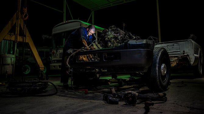 Senior Airman Christopher Moore removes the engine of a truck July 18, 2014, at an undisclosed location in Southwest Asia. Moore is a vehicle mechanic with the 386th Expeditionary Logistics Readiness Squadron. (U.S. Air Force photo/Staff Sgt. Jeremy Bowcock)
