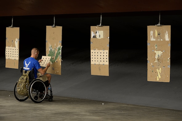 Jeremiah Means, Wounded Warrior athlete, checks his targets during competition shooting practice Aug. 3, 2014, at Fort Collins, Colo. The athletes are conducting their final group practices prior to the upcoming Invictus Games in London Sept. 10 through14 and the Warrior Games Sept. 28 through Oct. 4, 2014.  (U.S. Air Force photo\ Staff Sgt.Tim Chacon)