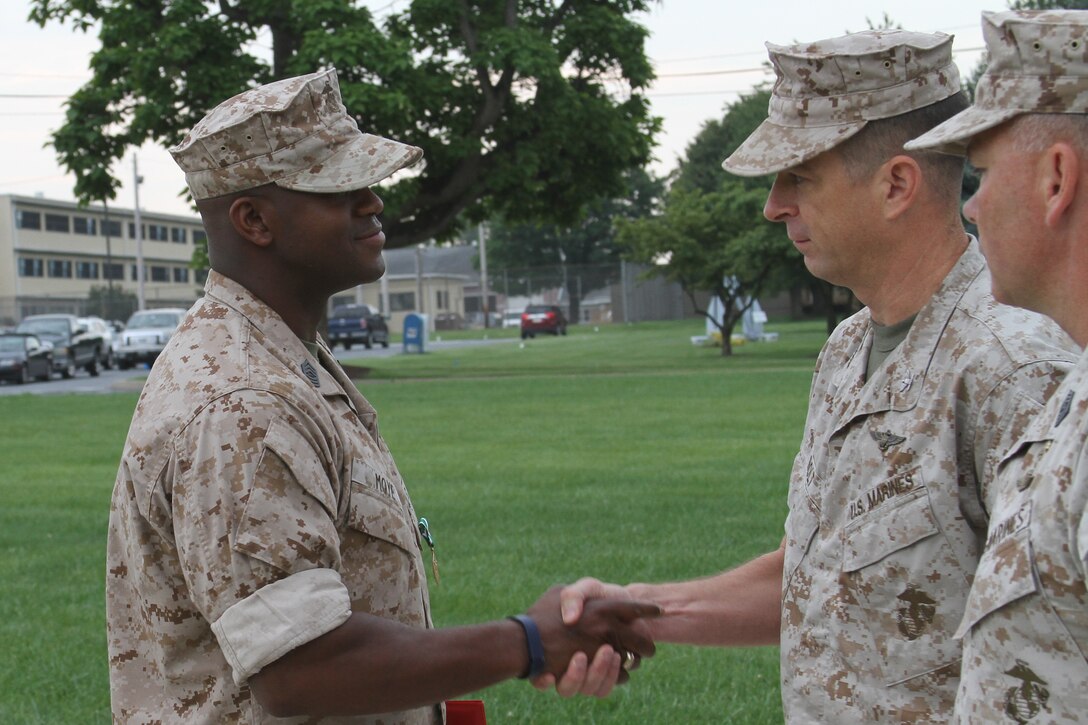 U.S. Marine Corps Master Sgt. Tommy Moye, a native of Quincy, Fla. and 1991 graduate of James A. Shanks High School, shakes the hand of U.S. Marine Corps Col John A. Bolt, the commanding officer of the 4th Marine Corps District, after receiving the Navy and Marine Corps Commendation Medal Aug. 6, 2014.  Moye served as a 4MCD training team member at the Defense Distribution Center Susquehanna in New Cumberland, Pa. As a training team member, he was responsible for monitoring and inspecting Recruiting Stations and Recruiting Sub-Stations across the district to ensure that systematic recruiting is a constant practice. Moye executed Permanent Change of Station orders to RS Raleigh and will now become the RI for RS Raleigh to ensure the recruiters of RS Raleigh recruit and enlist the most eligible for the U.S. Marine Corps. (U.S. Marine Corps photo by Cpl. Tyler Birky/Released)