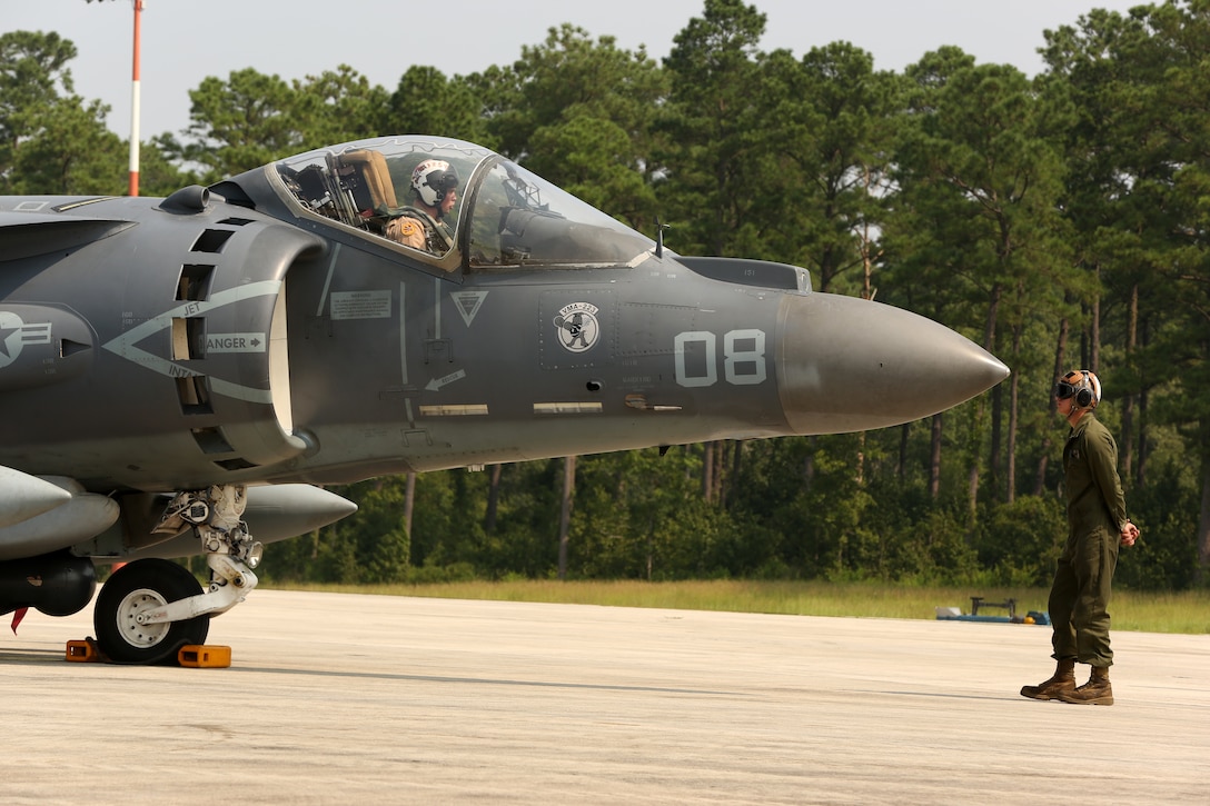 Capt. Andrew R. Christ, in the cockpit of an AV-8B Harrier, conducts pre-flight safety checks with Lance Cpl. Ryan E. Stanley at Marine Corps Air Station Cherry Point, N.C., Aug. 7, 2014.
Marine Attack Squadron 223 conducted the first East Coast Harrier squadron AIM-120A advanced medium-range air-to-air missile firing exercise off the coast of Oceana, Va., to help the squadron enhance its mission readiness. While the primary mission of VMA-223 is air-to-ground attack support for the Marine Air-Ground Task Force from the sea or land, the squadron's AV-8B pilots train to engage airborne enemies beyond visual range with radar guided air-to-air missiles.   
Christ is a quality assurance officer and naval aviator and Stanley is a fixed-wing aircraft mechanic, both with VMA-223.