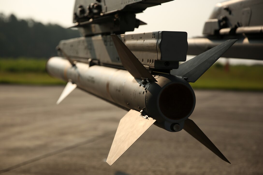 An AIM-120A advanced medium-range air-to-air missile is secured aboard an AV-8B Harrier with Marine Attack Squadron 223 at Marine Corps Air Station Cherry Point, N.C., Aug. 7, 2014. 
VMA-223 conducted the first East Coast Harrier squadron AMRAAM firing exercise off the coast of Oceana, Va., to help the squadron enhance its mission readiness. While the primary mission of VMA-223 is air-to-ground attack support for the Marine Air-Ground Task Force from the sea or land, the squadron's AV-8B pilots train to engage airborne enemies beyond visual range with radar guided air-to-air missiles. 