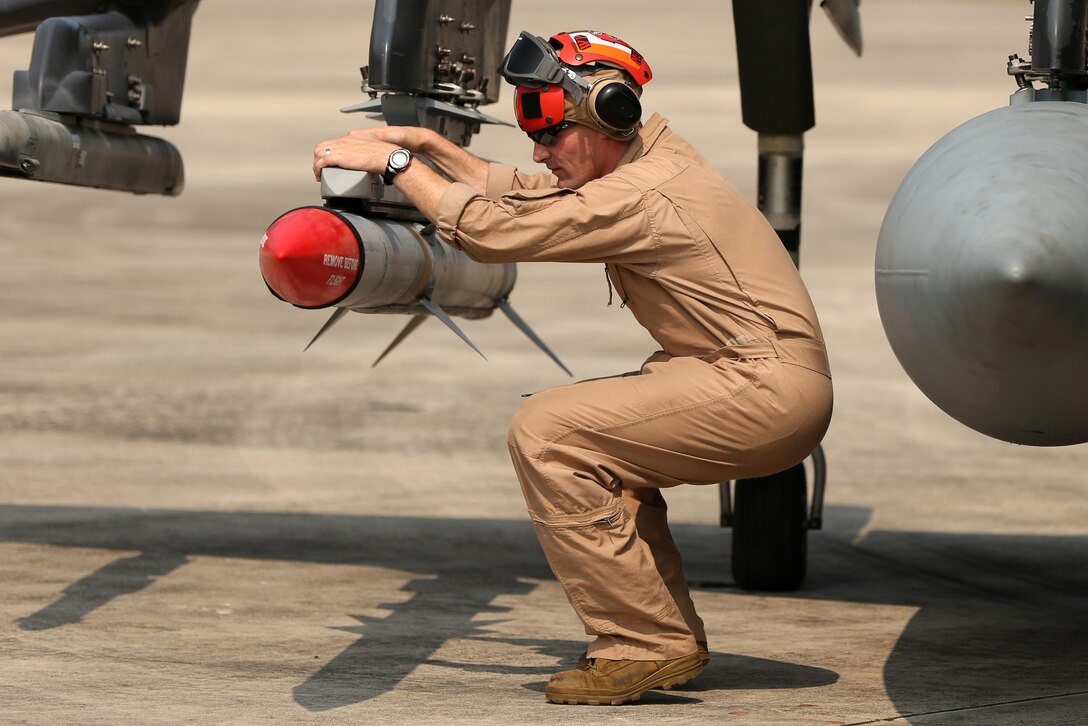 Gunnery Sgt. Robert J. McElmurry conducts a pre-flight safety check of an AIM-120A advanced medium-range air-to-air missile at Marine Corps Air Station Cherry Point, N.C., Aug. 7, 2014. 
Marine Attack Squadron 223 conducted the first East Coast Harrier squadron AMRAAM firing exercise off the coast of Oceana, Va., to help the squadron enhance its mission readiness. While the primary mission of VMA-223 is air-to-ground attack support for the Marine Air-Ground Task Force from the sea or land, the squadron's AV-8B pilots train to engage airborne enemies beyond visual range with radar guided air-to-air missiles. 
McElmurry is the aviation ordnance staff noncommissioned officer in charge with VMA-223 and native of Brodhead, Wis.