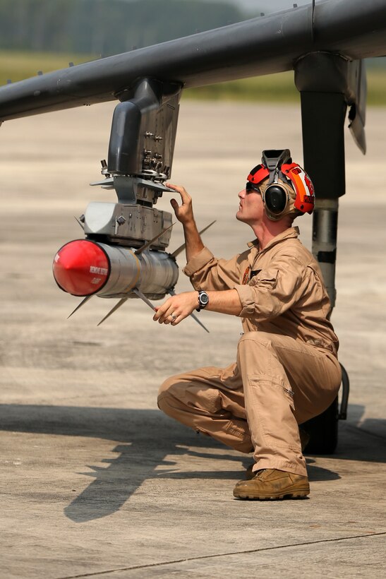 Gunnery Sgt. Robert J. McElmurry conducts a pre-flight safety check of an AIM-120A advanced medium-range air-to-air missile at Marine Corps Air Station Cherry Point, N.C., Aug. 7, 2014. 
Marine Attack Squadron 223 conducted the first East Coast Harrier squadron AMRAAM firing exercise off the coast of Oceana, Va., to help the squadron enhance its mission readiness. While the primary mission of VMA-223 is air-to-ground attack support for the Marine Air-Ground Task Force from the sea or land, the squadron's AV-8B pilots train to engage airborne enemies beyond visual range with radar guided air-to-air missiles. 
McElmurry is the aviation ordnance staff noncommissioned officer in charge with VMA-223 and native of Brodhead, Wis.  