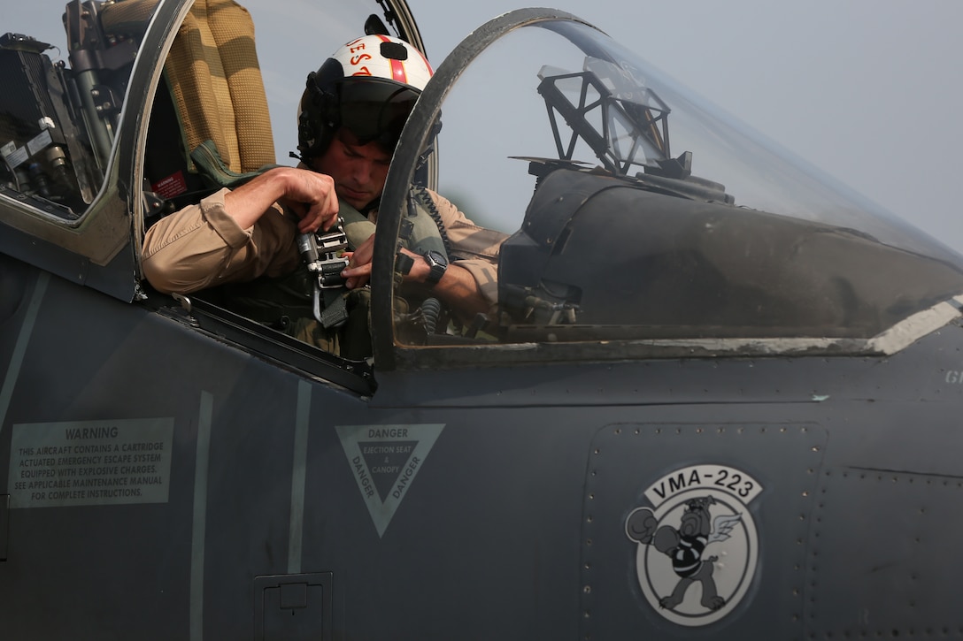 Capt. Andrew R. Christ secures a safety harness during a pre-flight safety check in the cockpit of an AV-8B Harrier with Marine Attack Squadron 223 at Marine Corps Air Station Cherry Point, N.C., Aug. 7, 2014.
VMA-223 conducted the first East Coast Harrier squadron AIM-120A advanced medium-range air-to-air missile firing exercise off the coast of Oceana, Va., to help the squadron enhance its mission readiness.
While the primary mission of VMA-223 is air-to-ground attack support for the Marine Air-Ground Task Force from the sea or land, the squadron's AV-8B pilots train to engage airborne enemies beyond visual range with radar guided air-to-air missiles.   
Christ is a quality assurance officer and naval aviator with VMA-223.