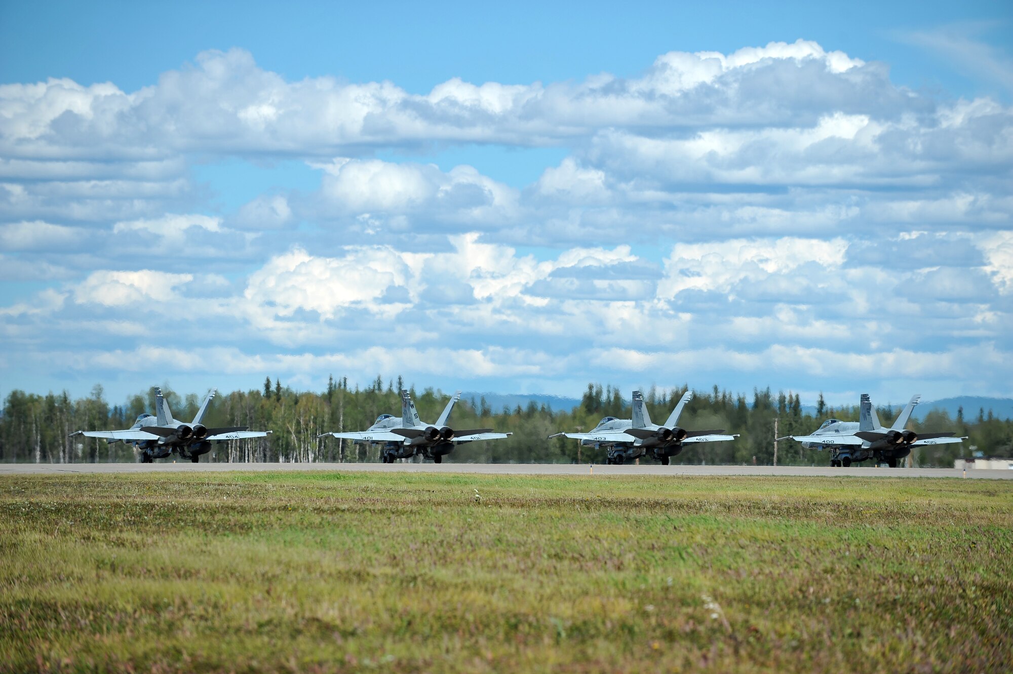 U.S. Marine Corps F/A-18 Hornets assigned to the Marine Fighter Attack Squadron 323, Marine Corps Air Station Miramar, Calif., prepare to launch during RED FLAG-Alaska 14-3 Aug. 8, 2014, Eielson Air Force Base, Alaska. The EA-18G Growler performs escort jamming as well as the traditional standoff jamming missions. (U.S. Air Force photo by Staff Sgt. Jim Araos/Released)