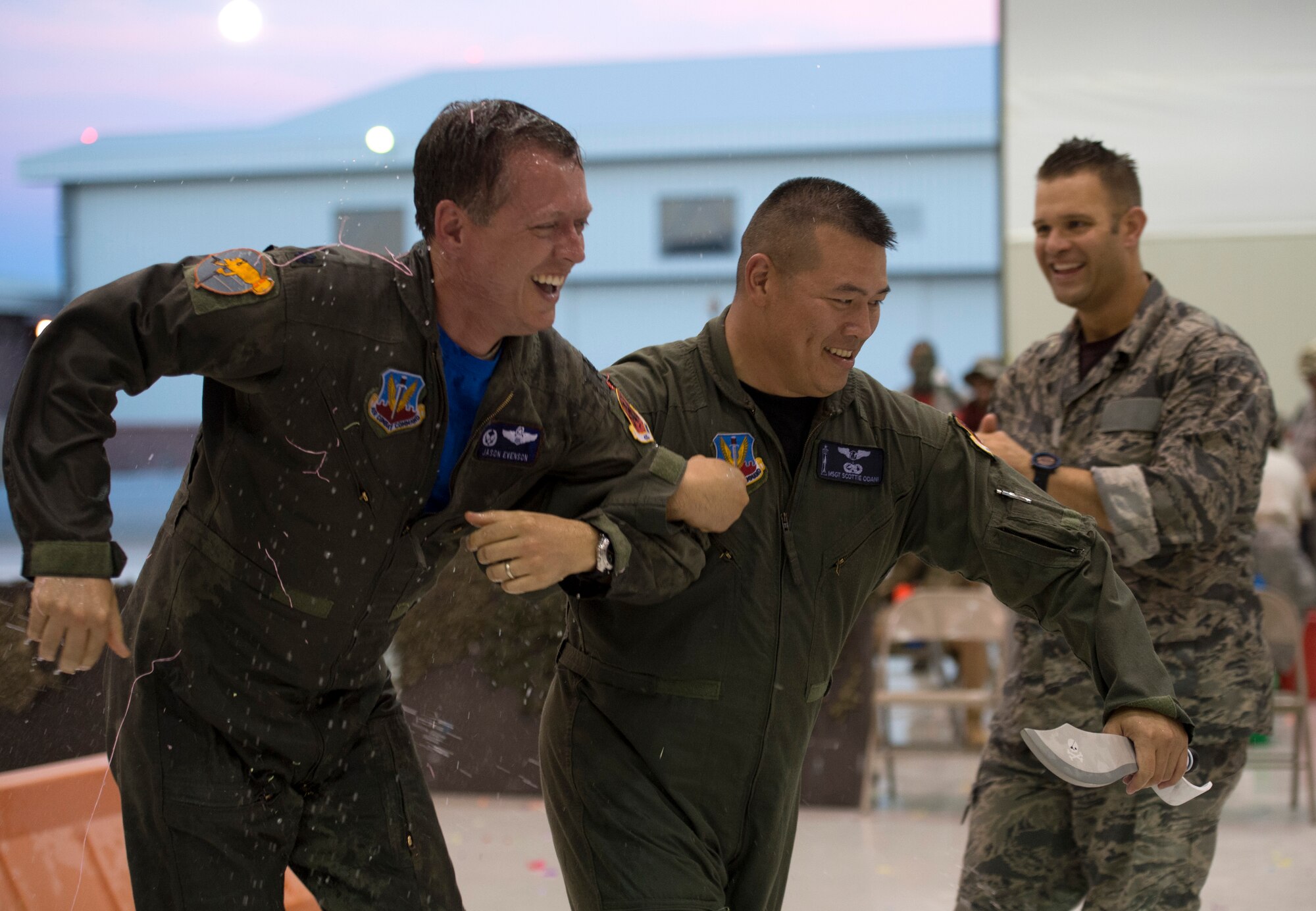 Airmen assigned to the 432nd Wing run through the hangar while being shot with water guns during the first ever combat dining-in at Creech Air Force Base, Nev., July 11, 2014. . Participants brought water balloons and water guns and engaged in friendly water “warfare” to help build camaraderie. (U.S. Air Force photo by Airman 1st Class Christian Clausen/Released)