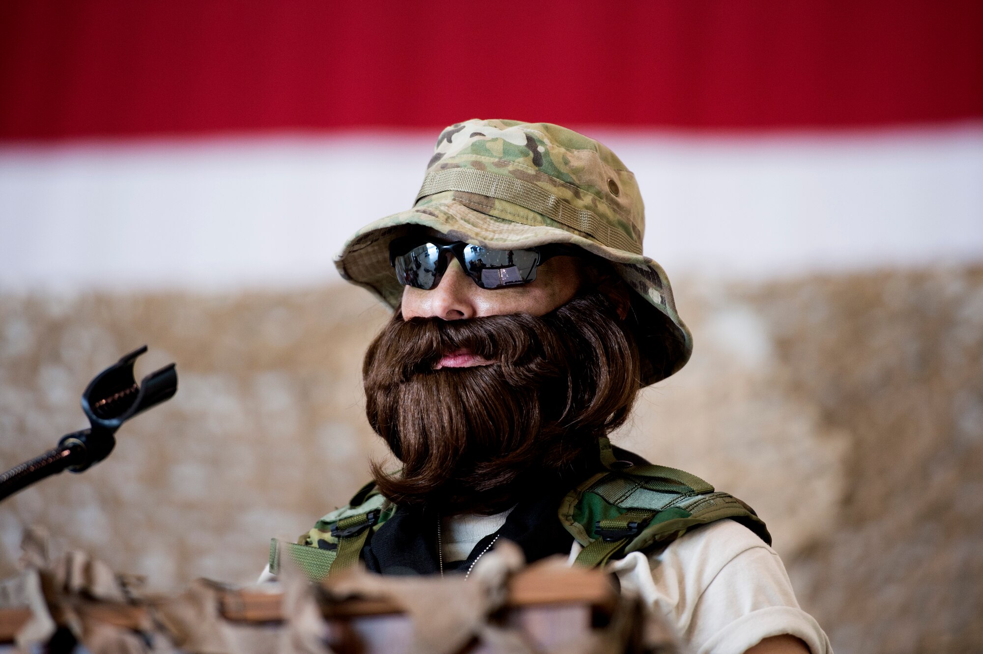 Senior Master Sgt. Christin Bisson, 18th Reconnaissance Squadron superintendent and combat dining-in grog master, delivers a speech on Creech Air Force Base, Nev., July 11, 2014. During the event, participants were allowed to wear any combination of creatively revised past or present Air Force utility or combat uniforms. (U.S. Air Force photo by Tech. Sgt. Shad Eidson/Released)