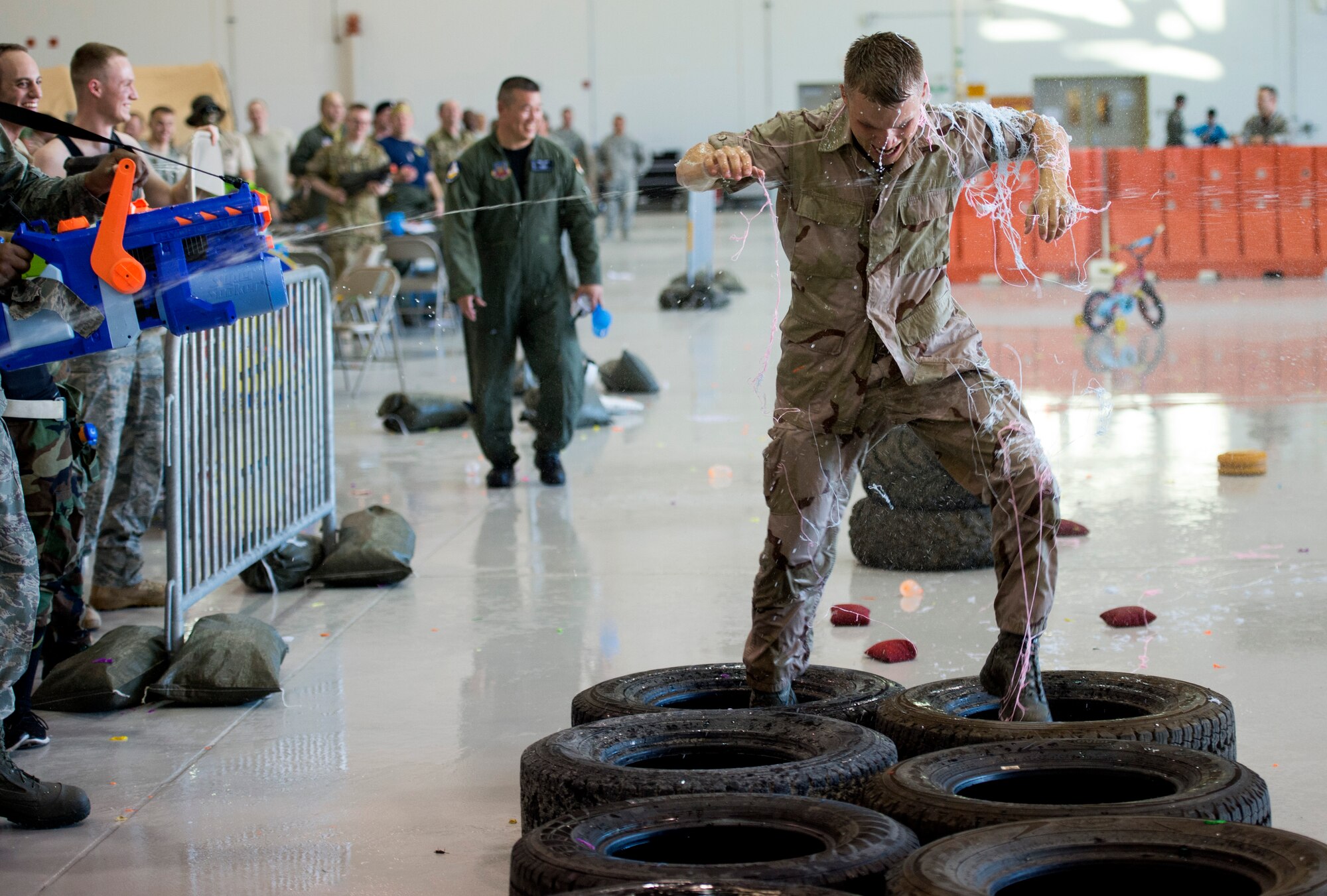 Tech. Sgt. Noah Stamps, 432nd Wing Chapel Operations NCO in charge and combat dining-in emcee, runs through the obstacle course during the first ever combat dining-in at Creech Air Force Base, Nev., July 11, 2014. During the event, participants were allowed to wear any combination of creatively revised past or present Air Force utility or combat uniforms. (U.S. Air Force photo by Tech. Sgt. Shad Eidson/Released)
