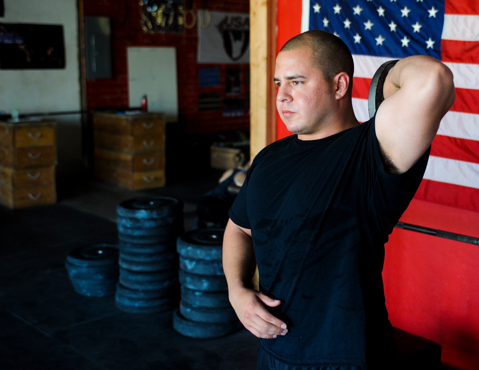 U.S. Air Force Staff Sgt. David Labrie, 612th Support Squadron lead meteorologist and powerlifter, warms up before a training session at a crossfit gym in Tucson, Ariz., Aug. 7, 2014. Labrie won second place at a 2014 National Powerlifting competition in Las Vegas, July 27. (U.S. Air Force photo by Airman 1st Class Sivan Veazie/Released)