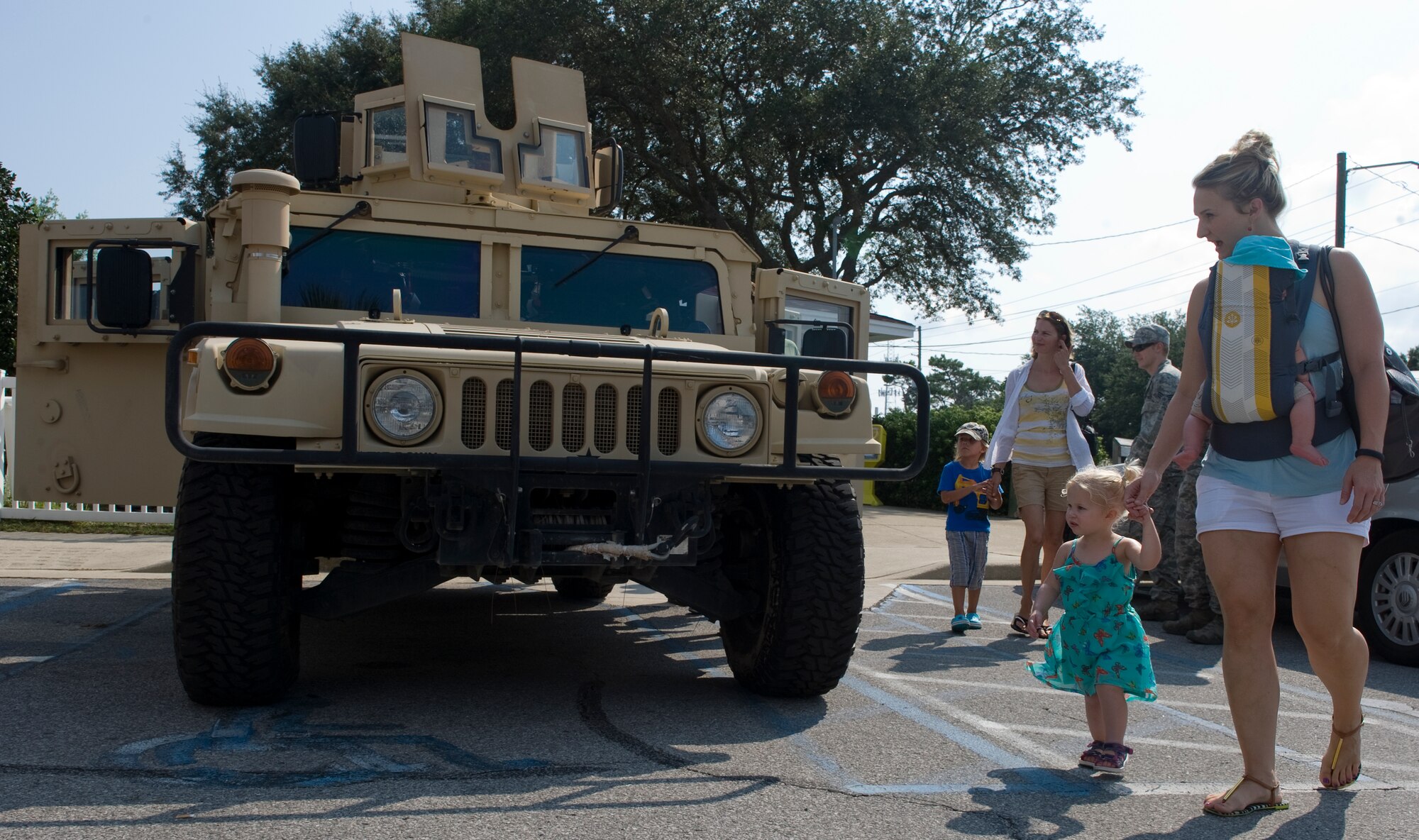 Families from the local community check out a 1st Special Operations Civil Engineer Squadron Humvee during the 16th Annual Truck Day at the Destin Community Center in Destin, Fla., Aug. 7, 2014. The event featured vehicles from various businesses and services from around the Emerald Coast. (U.S. Air Force photo/Senior Airman Kentavist P. Brackin)
