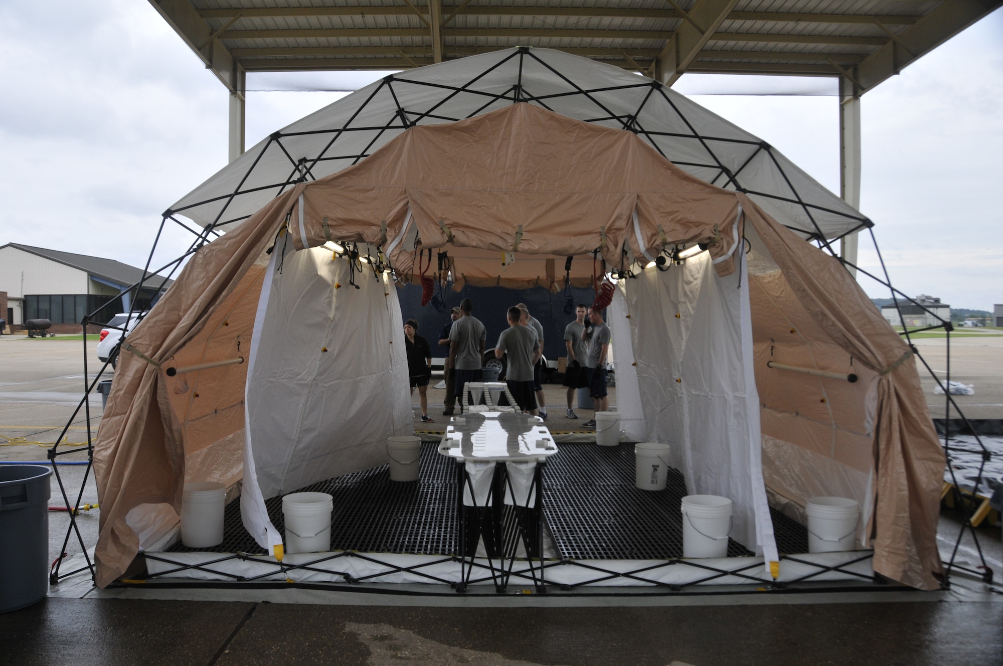 Airmen from the 188th Wing attend decontamination training at Ebbing Air National Guard Base, Arkansas, July 17. The volunteers, who were from various parts of the wing, learned how to set up a decontamination tent and clean victims of various chemical or nuclear hazards. This training will aid the wing in its mission to support Arkansas citizens in times of disaster. (U.S. Air National Guard photo by Staff Sgt. John Suleski/released)