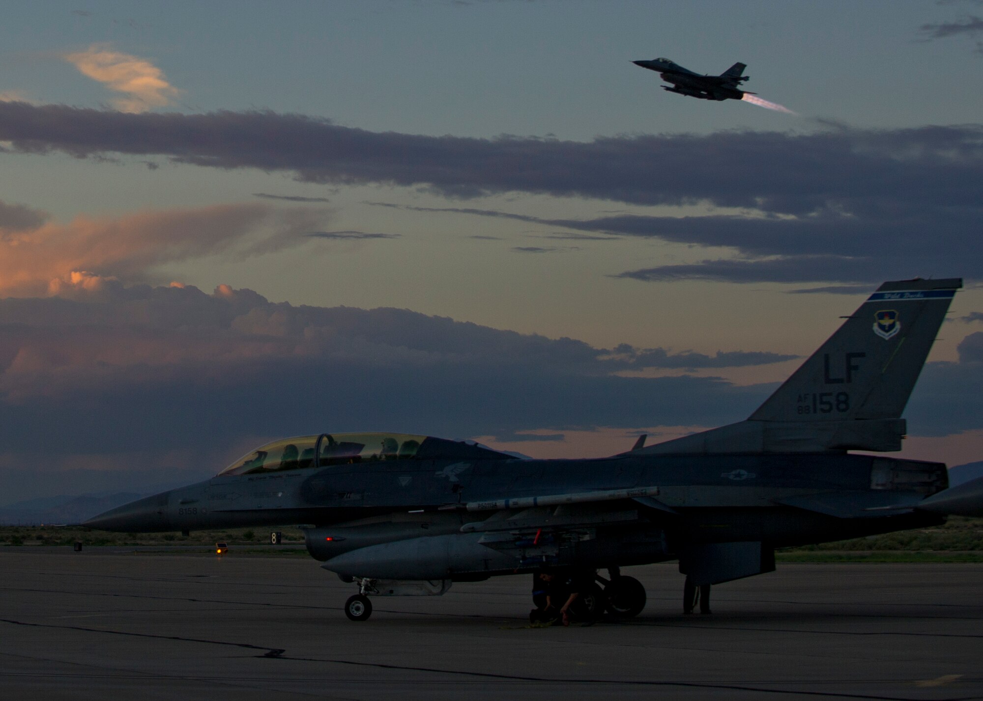 Pilots from the 54th Fighter Group prepare for takeoff in an F-16 Fighting Falcon for a training sortie over the White Sands Missile Range's 10,000 square mile range at Holloman Air force Base, N.M., Aug. 5. The 54th FG is a detachment of Luke AFB, Ariz., and is stationed on Holloman to facilitate high-speed training, live fire weapons training, and night flying operations. (U.S. Air Force photo by Airman 1st Class Leah Ferrante/Released)