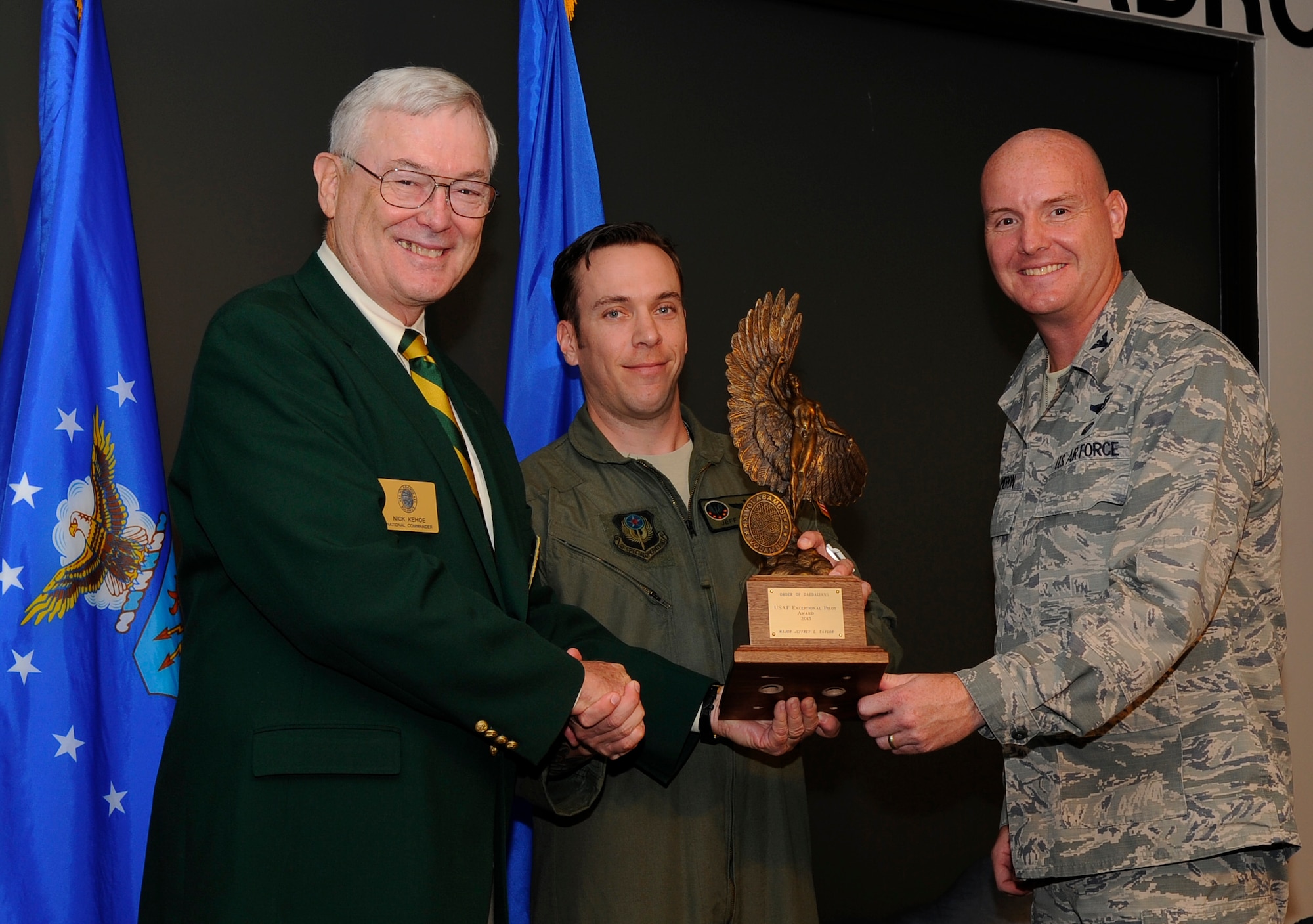 Retired Lt. Gen. Nick Kehoe, National Commander of the Order of Daedalians, Maj. Jeffery Taylor, 15th Special Operations Squadron MC-130H pilot, and Col. Shawn Cameron, 1st Special Operations Group commander, pose for a photo during an award ceremony Aug. 7, 2014 at the 15th SOS auditorium on Hurlburt Field, Fla. Taylor received the 2013 Daedalian Exceptional Pilot of the Year award for his courage and leadership in support of air operations throughout Afghanistan. (U.S. Air Force photo by Staff Sgt. Sarah Hanson)