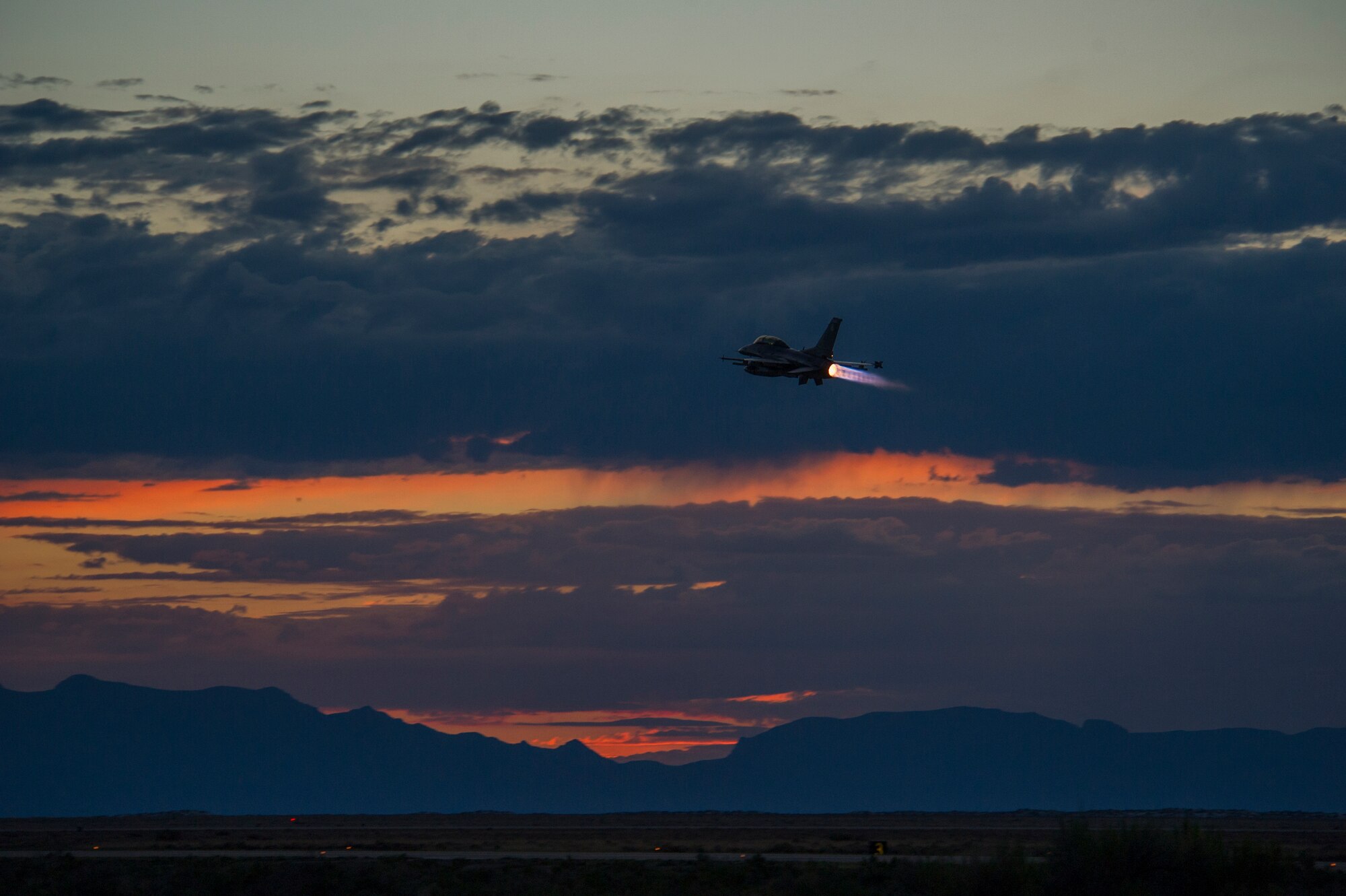 An F-16 Fighting Falcon takes off to participate in a night flying training sortie at Holloman Air Force Base, N.M., Aug. 6. F-16 Fighting Falcons from the 54th Fighter Group train over the White Sands Missile Range's 10,000 square mile range. The 54th FG is a detachment of Luke AFB, Ariz., and is stationed on Holloman to facilitate high-speed training, live fire weapons training, and night flying operations. (U.S. Air Force photo by Airman 1st Class Aaron Montoya / Released)