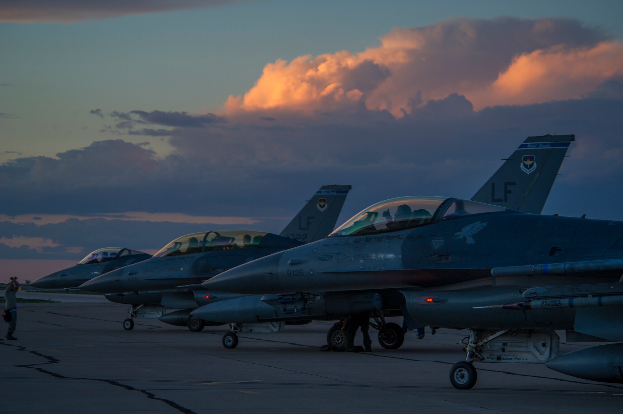 F-16 Fighting Falcons line up and prepare for takeoff during a night flying sortie at Holloman Air Force Base, N.M., Aug. 6. F-16's from the 54th Fighter Group trains over the White Sands Missile Range's 10,000 square mile range. The 54th FG is a detachment of Luke AFB, Ariz, and is stationed on Holloman to facilitate high-speed training, live fire weapons training, and night flying operations. (U.S. Air Force photo by Airman 1st Class Aaron Montoya / Released)