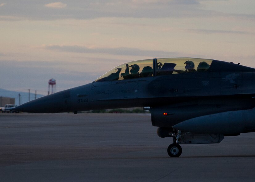 Two pilots from the 54th Fighter Group taxi in an F-16 Fighting Falcon, prior to a training sortie over the White Sands Missile Range's 10,000 square mile range at Holloman Air force Base, N.M., Aug. 5. The 54th FG is a detachment of Luke AFB, Ariz., and is stationed on Holloman to facilitate high-speed training, live fire weapons training, and night flying operations. (U.S. Air Force photo by Airman 1st Class Leah Ferrante/Released)