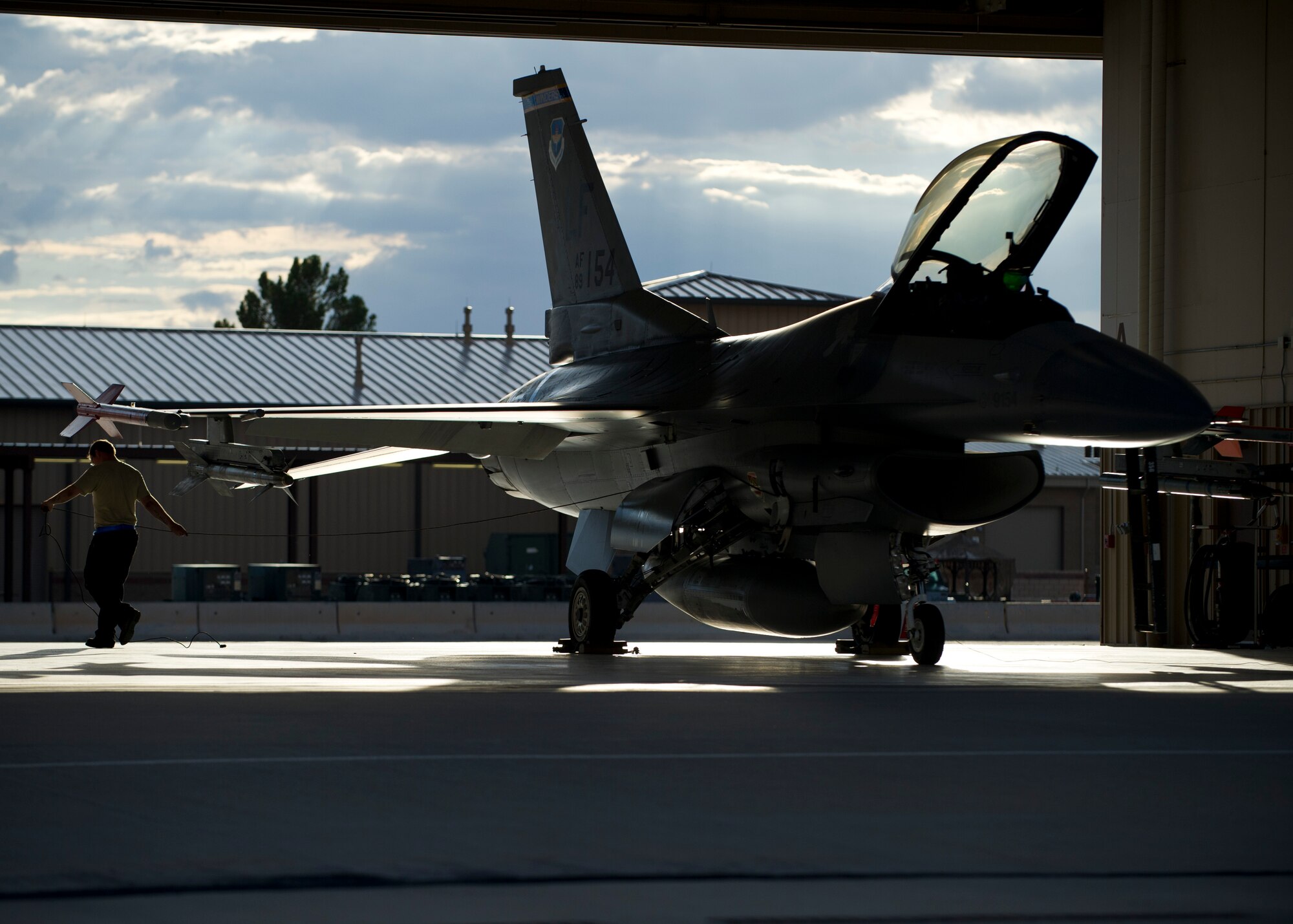 A member of a 311th Aircraft Maintenance Squadron prepares an F-16 Fighting Falcon for a training sortie over the White Sands Missile Range's 10,000 square mile range at Holloman Air force Base, N.M., Aug. 5. The 54th FG is a detachment of Luke AFB, Ariz., and is stationed on Holloman to facilitate high-speed training, live fire weapons training, and night flying operations. (U.S. Air Force photo by Airman 1st Class Leah Ferrante/Released)
