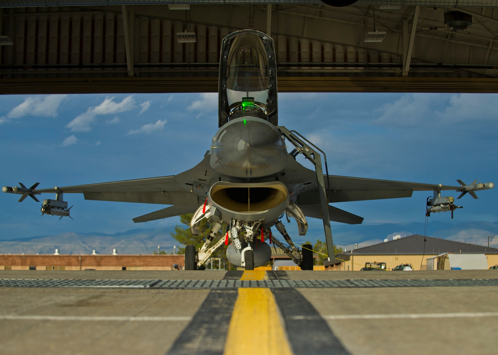 Crew members prepare an F-16 Fighting Falcon for a training sortie over the White Sands Missile Range's 10,000 square mile range at Holloman Air force Base, N.M., Aug. 5. The 54th FG is a detachment of Luke AFB, Ariz., and is stationed on Holloman to facilitate high-speed training, live fire weapons training, and night flying operations. (U.S. Air Force photo by Airman 1st Class Leah Ferrante/Released)
