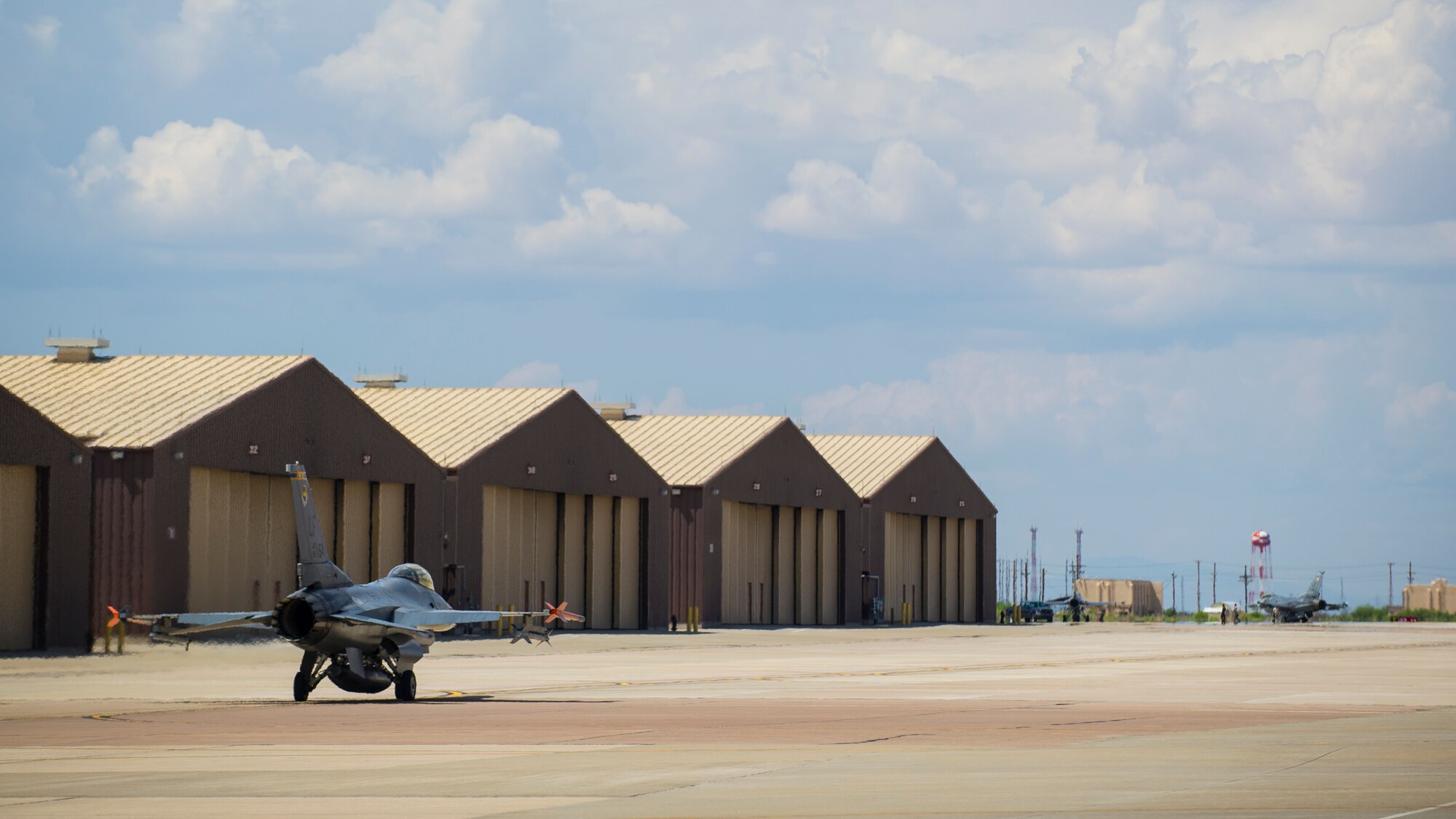 An F-16 Fighting Falcon taxis toward the runway in preparation for takeoff before a training sortie over the White Sands Missile Range's 10,000 square mile range at Holloman Air Force Base, N.M., Aug 5. The 54th FG is a detachment of Luke AFB, Ariz., and is stationed on Holloman to facilitate high-speed training, live fire weapons training, and night flying operations. (U.S. Air Force photo by Airman 1st Class Aaron Montoya / Released)