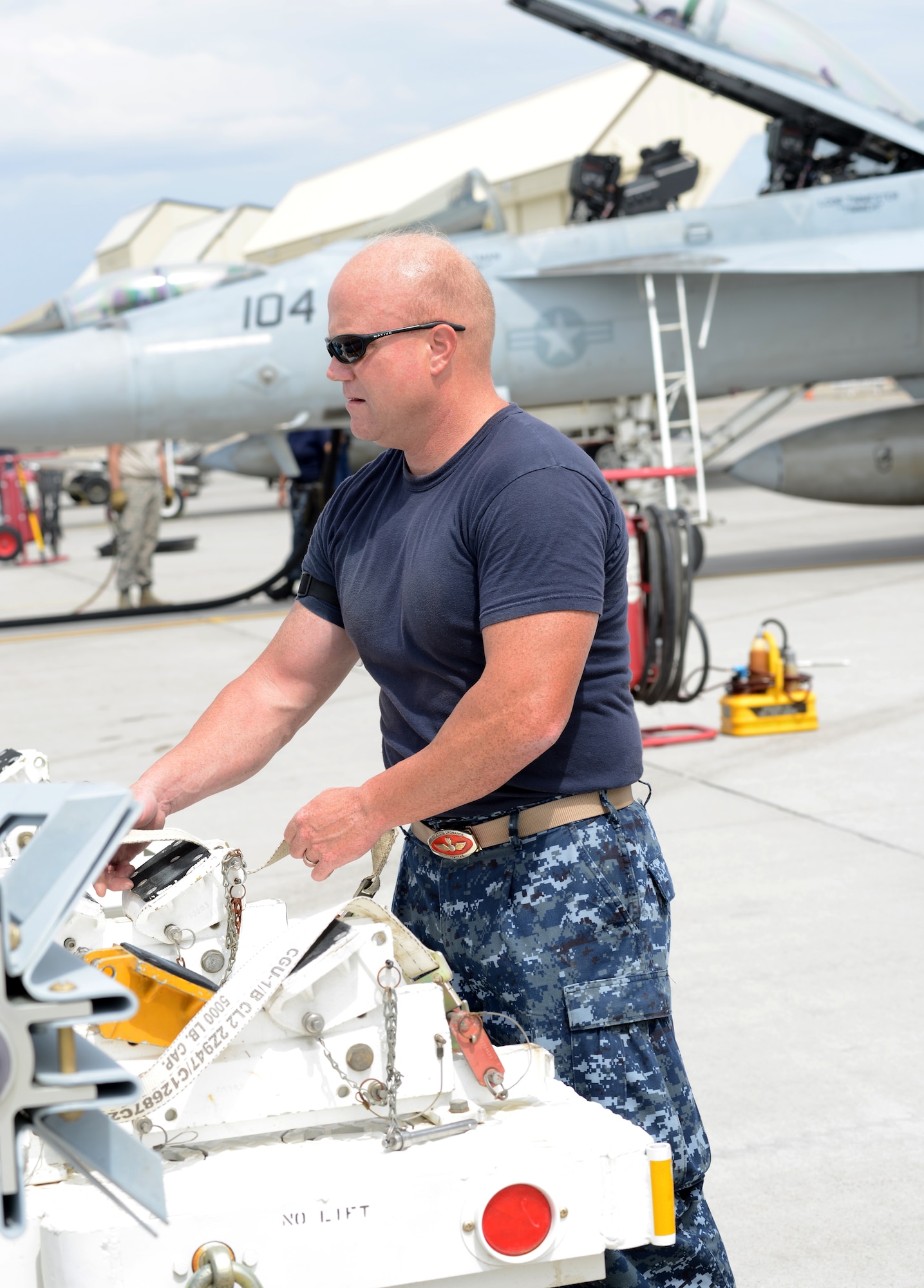 U.S. Navy Chief Warrant Officer 3 James Kelly, VFA 154 weapons officer, stands on the flightline before loading a munition Aug. 4, 2014, at Mountain Home Air Force Base, Idaho. More than 75 members of VFA 154, Naval Air Station Lemoore, Calif., are currently on temporary duty assignment here as a way to get combat training scenarios accomplished. (U.S. Air Force photo by Senior Airman Benjamin Sutton/Released)