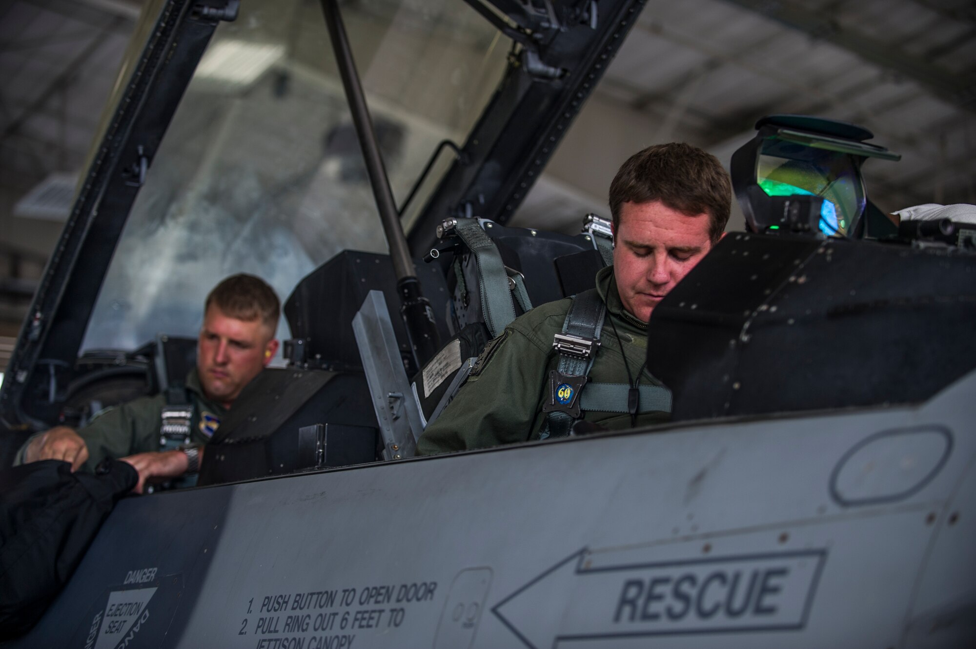 Captain Jerrod Sonderman, 54th Fighter Group assistant chief of weapons, and Capt. Howard Turner, 54th Fighter Group pilot, perform pre-flight checks prior to a training sortie over the White Sands Missile Range's 10,000 square mile range at Holloman Air Force Base, N.M., Aug. 5. The 54th FG is a detachment of Luke AFB, Ariz., and is stationed on Holloman to facilitate high-speed training, live fire weapons training, and night flying operations. (U.S. Air Force photo by Airman 1st Class Aaron Montoya / Released)