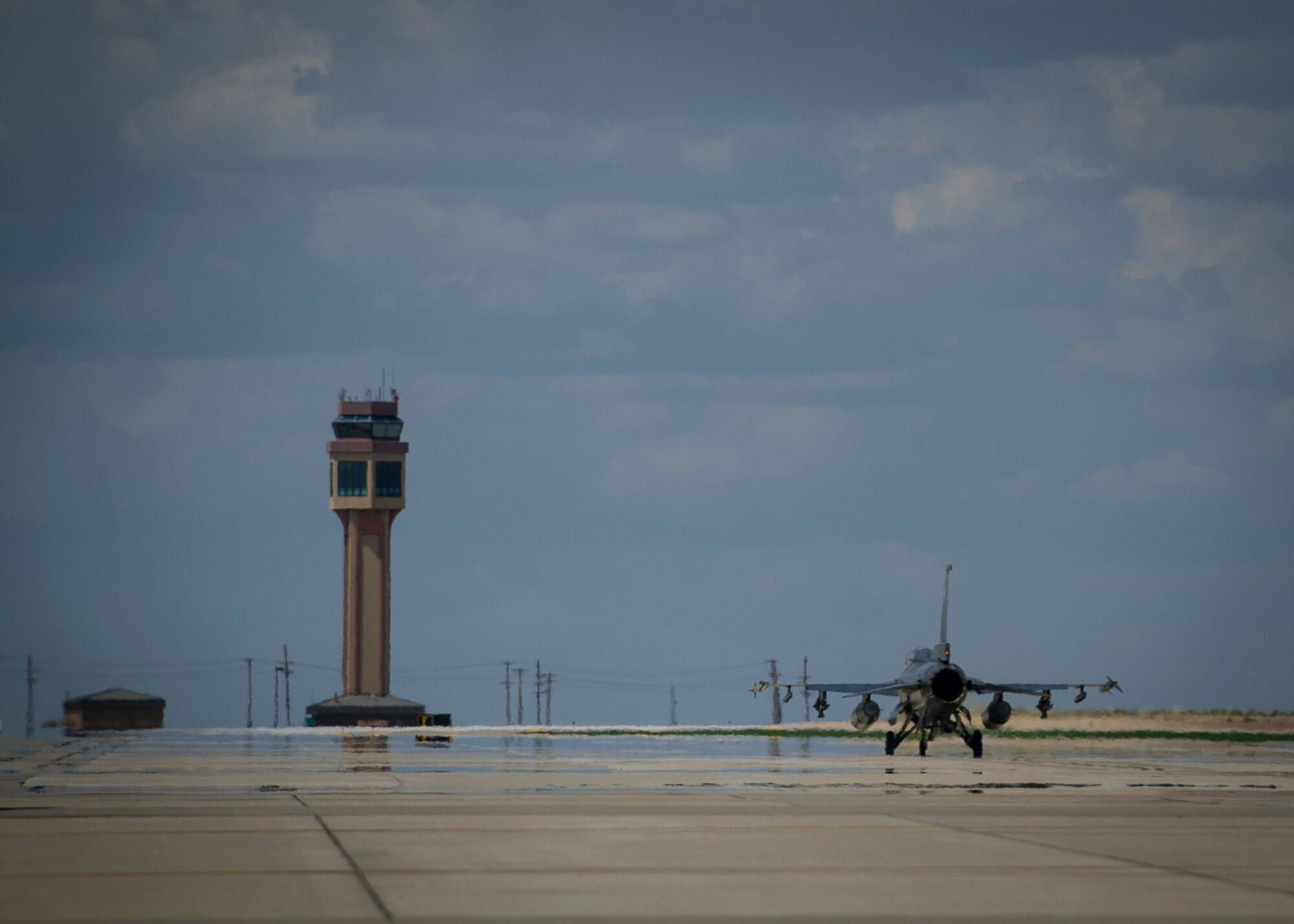 An F-16 Fighting Falcon taxis toward the runway prior to takeoff for a training sortie over the White Sands Missile Range's 10,000 square mile range at Holloman Air Force Base, N.M., Aug. 5. The 54th FG is a detachment of Luke AFB, Ariz., and is stationed on Holloman to facilitate high-speed training, live fire weapons training, and night flying operations. (U.S. Air Force photo by Airman 1st Class Aaron Montoya / Released)