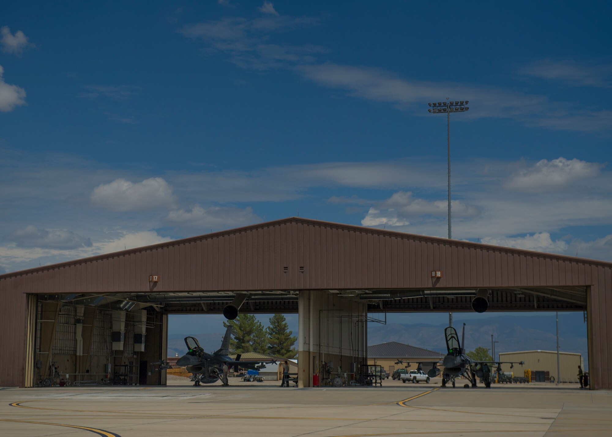 Two F-16 Fighting Falcons from the 54th Fighter Group prepare for a training sortie over the White Sands Missile Range's 10,000 square mile range at Holloman Air Force Base, N.M., Aug. 5. The 54th FG is a detachment of Luke AFB, Ariz., and is stationed on Holloman to facilitate high-speed training, live fire weapons training, and night flying operations. (U.S. Air Force photo by Airman 1st Class Aaron Montoya / Released)