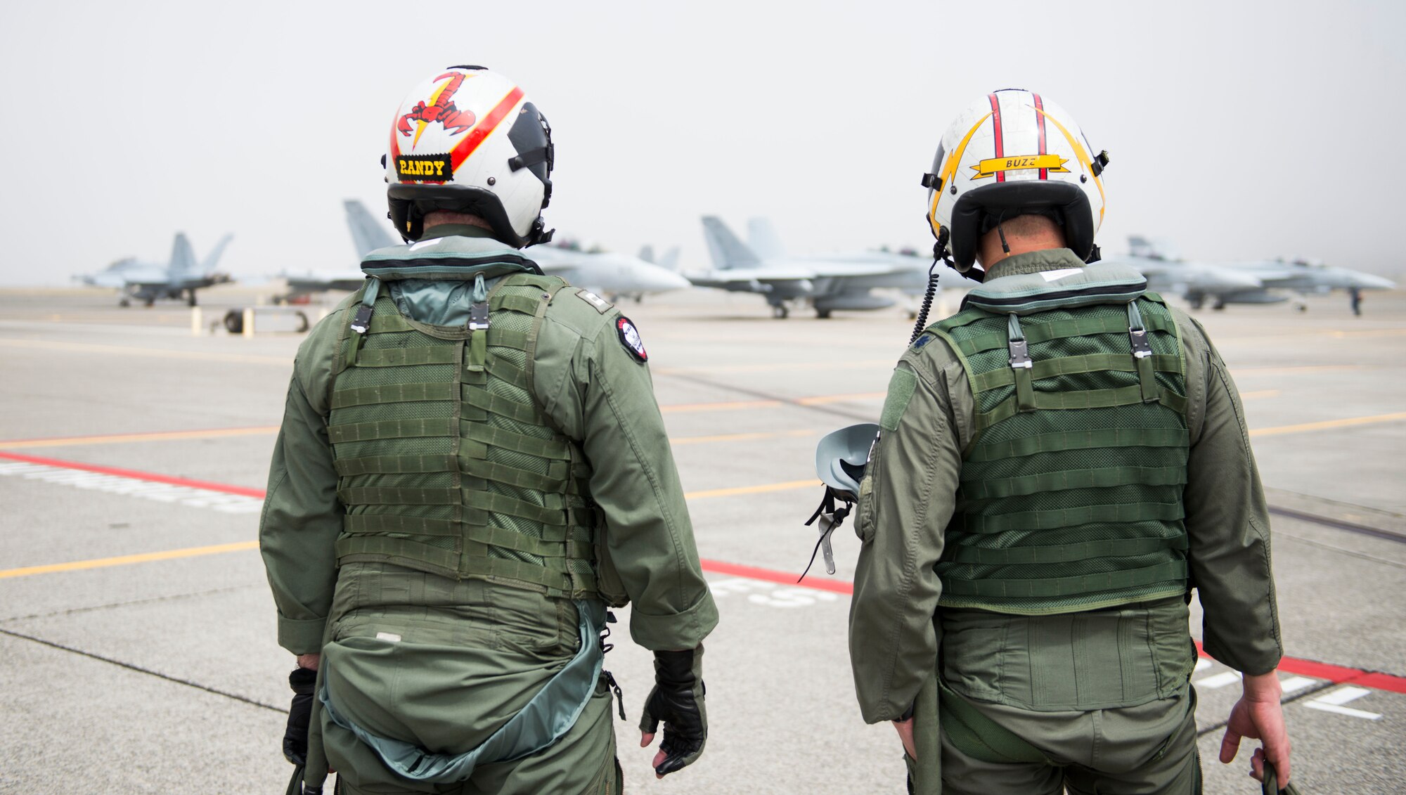 U.S. Air Force Lt. Col. Don Keen, 390th Electronic Combat Squadron commander, and Lt. Randy Scoby, VAQ-129 EA-18G Growler electronic warfare officer, talk before a flight on the EA-18G Growler at Naval Air Station Whidbey Island, Wash., August 7, 2014. The missions of the Growler will be strategic resources for Air Force aircrew and combat forces. (U.S. Air Force photo by Airman 1st Class Malissa Lott/RELEASED)