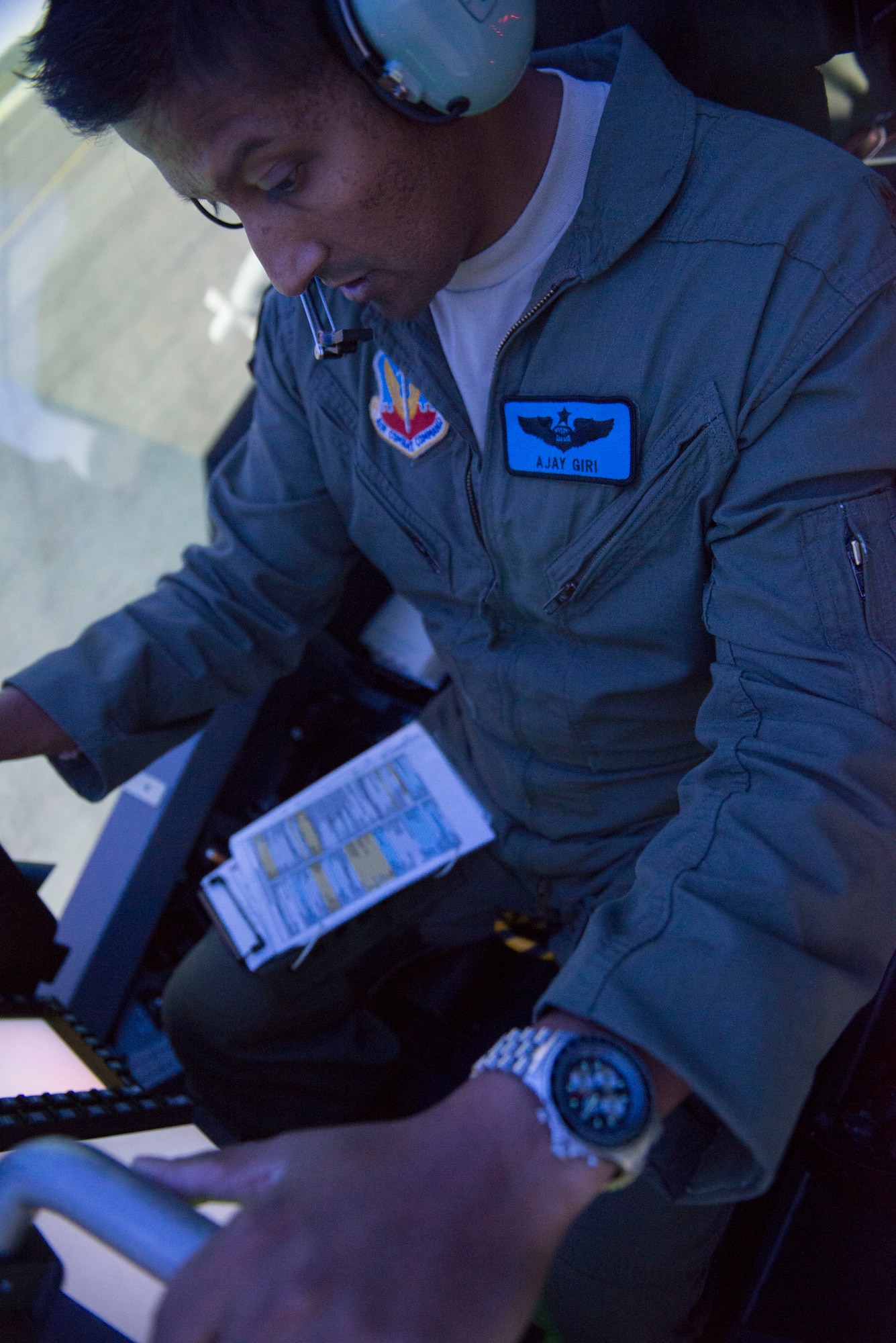 U.S. Air Force Major Ajay Giri, VAQ-131 Training Squadron, performs checks before a simulated flight at Naval Air Station Whidbey Island, Wash., August 7, 2014. Giri is one of the many Air Force weapon systems officers who are transitioning to electronic warfare officers. (U.S. Air Force photo by Airman 1st Class Malissa Lott/RELEASED)