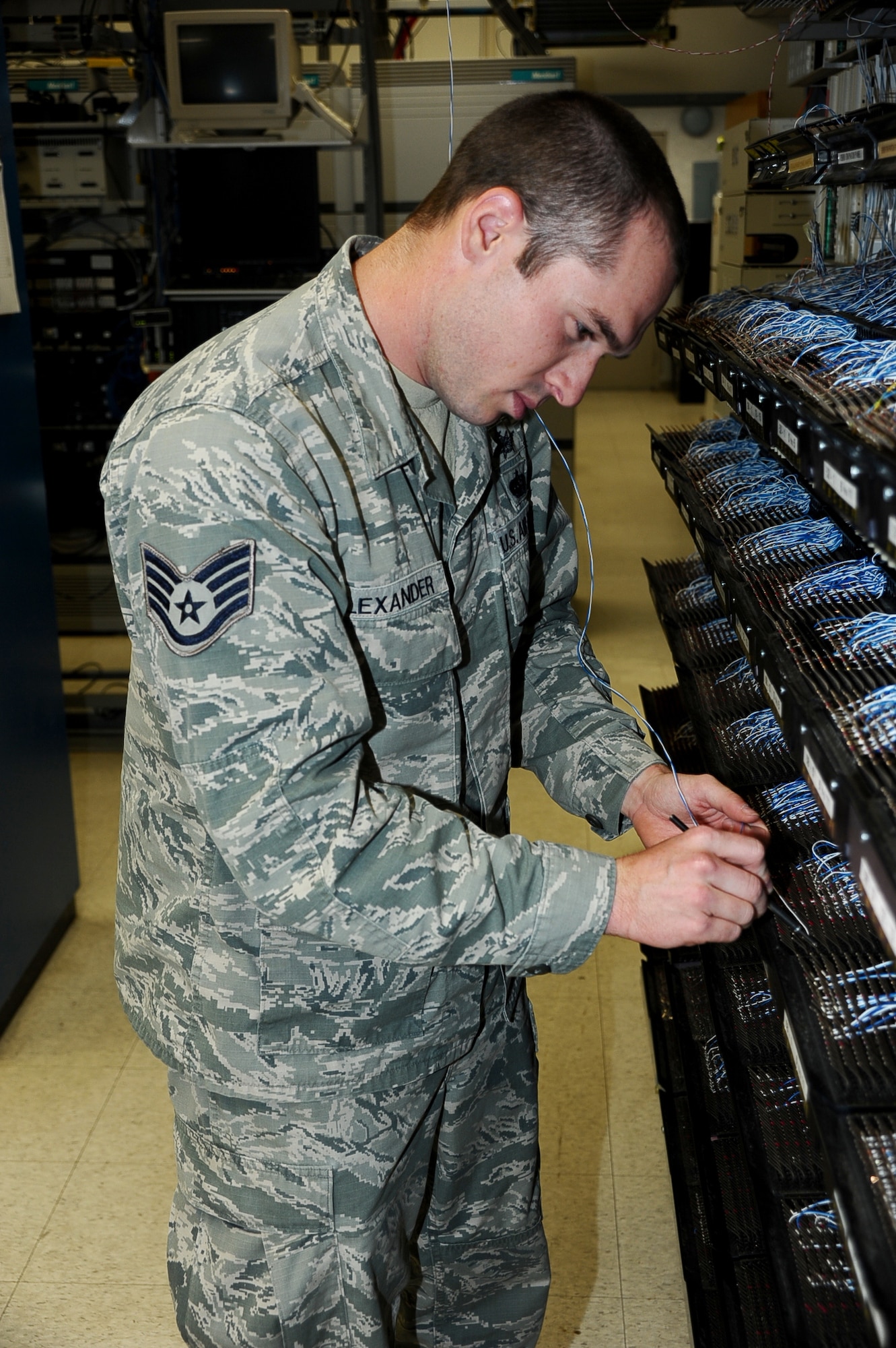 Staff Sgt. Kassel Alexander, 14th Communications Squadron Voice Networks NCO in charge, adds a new phone line to the system Aug. 7 at Columbus Air Force Base. The mission of the 14 CS is to support the Defense of the United States by developing and maintaining the best communications and information systems and personnel. (U.S. Air Force photo/ Airman John Day)