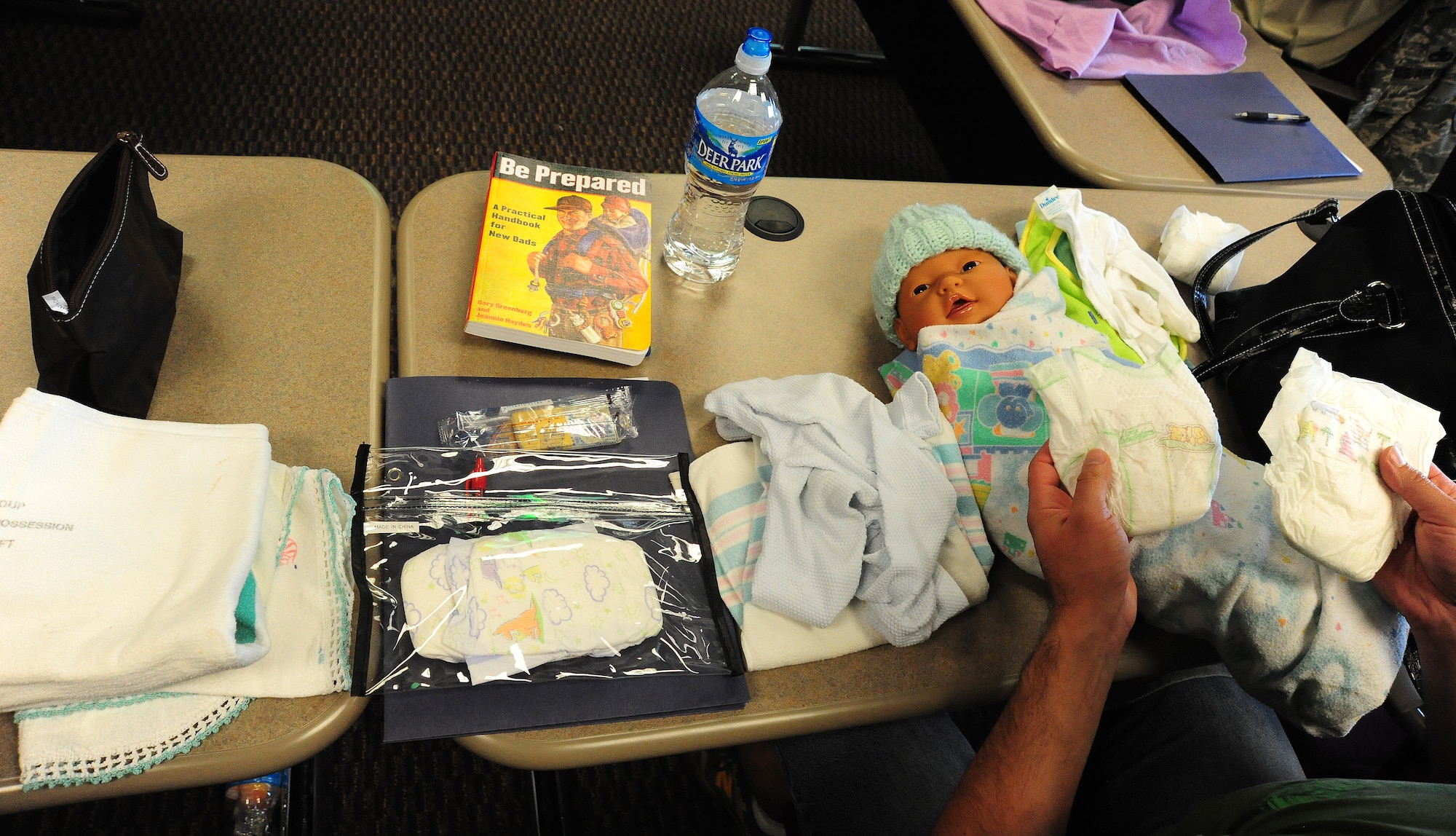 Staff Sgt. Sky Meashintubby, 509th Munitions Squadron load delivery dispatcher, sorts through items during the "Dads: The Basics" at the Professional Development Center at Whiteman Air Force Base, Mo., July 18, 2014.The class included hand-on drills and information about pregnancy and post-partum stress. (U.S. Air Force photo by Staff Sgt. Nick Wilson/Released)