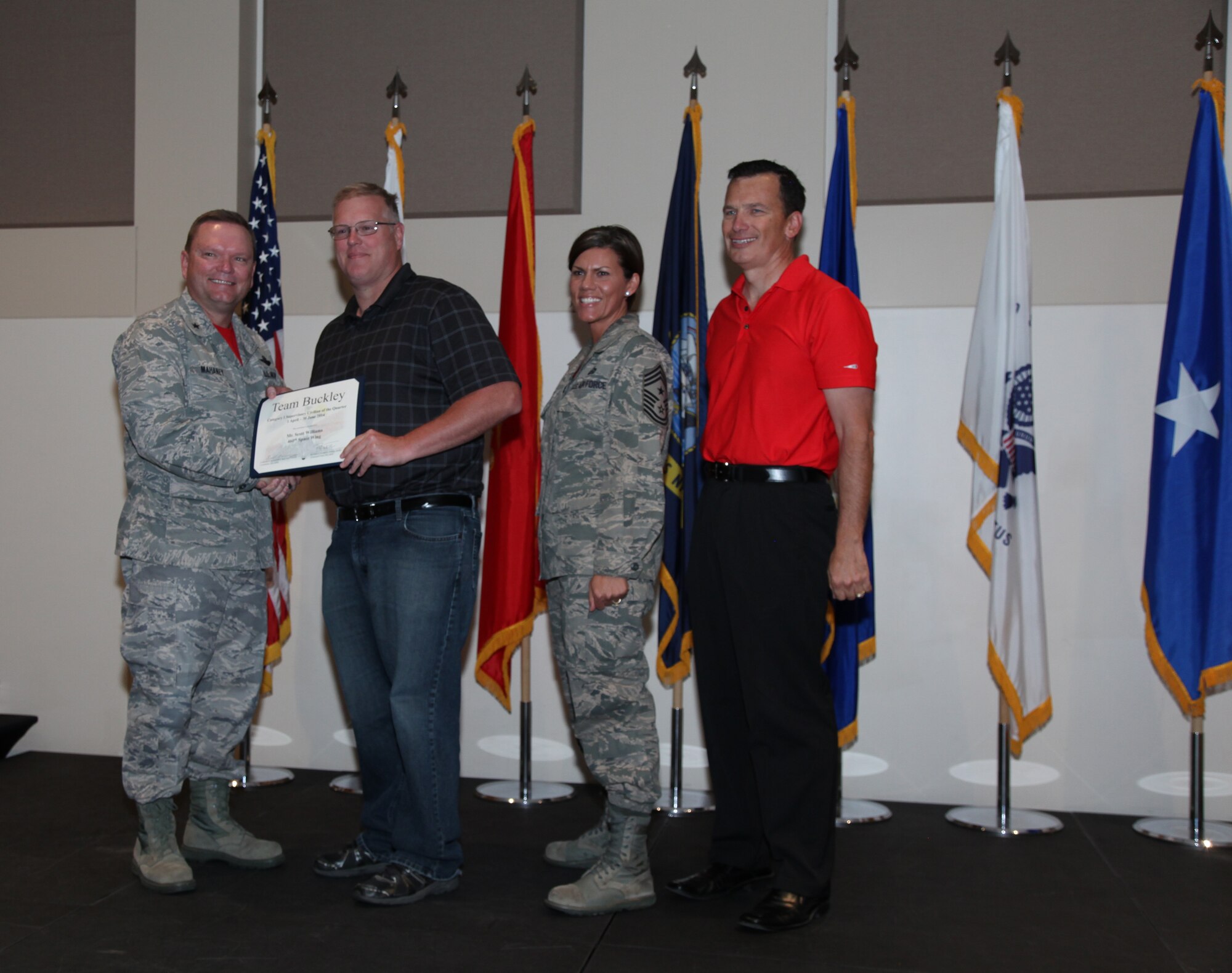 Brig. Gen. Samuel "Bo" Mahaney, Air Reserve Personnel Center commander, Chief Master Sgt. Ruthe Flores, ARPC command chief, and Scott Fromm, ARPC director of staff, present the Category I Supervisory Civilian award to Scott Williams, 460th Space Wing, during the Team Buckley quarterly awards ceremony Aug. 8 on Buckley Air Force Base, Colo. (U.S. Air Force photo/Quinn Jacobson)