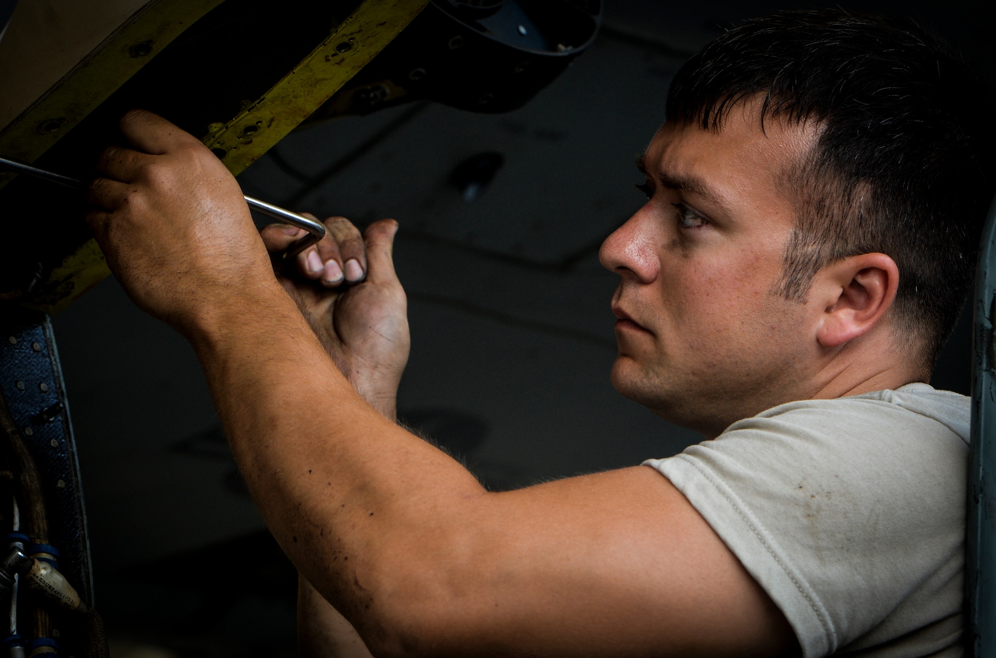 Senior Airman Chad Pearsall, 8th AMU crew chief, unscrews a panel from a CV-22 Osprey on Hurlburt Field, Fla., Aug. 8, 2014. Crew chiefs are responsible for day-to-day maintenance, including preflight, postflight, special inspections and phase inspections. (U.S. Air Force photo/Senior Airman Christopher Callaway) 