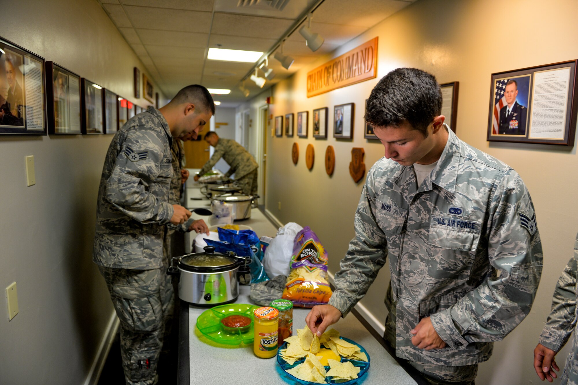 Staff Sgt. Caleb Moss, 8th Aircraft Maintenance Unit supply journeyman, prepares chips and dip for lunch at the Airmen Leadership School house on Hurlburt Field, Fla., August 5, 2014. Students invited supervisors and senior leadership to have lunch with them during a diversity training day. (U.S. Air Force photo/Senior Airman Christopher Callaway) 