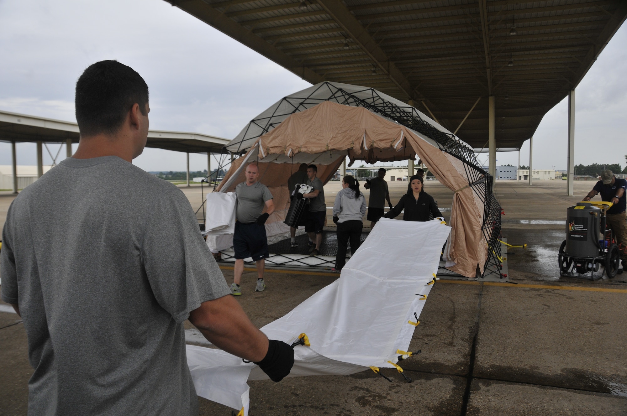 Airmen from the 188th Wing set up a medical decontamination tent during decon training at Ebbing Air National Guard Base, Arkansas, July 17. The volunteers, who were from various parts of the wing, learned how to set up a decontamination tent and clean victims of various chemical or nuclear hazards. This training will aid the wing in its mission to support Arkansas citizens in times of disaster. (U.S. Air National Guard photo by Staff Sgt. John Suleski/released)