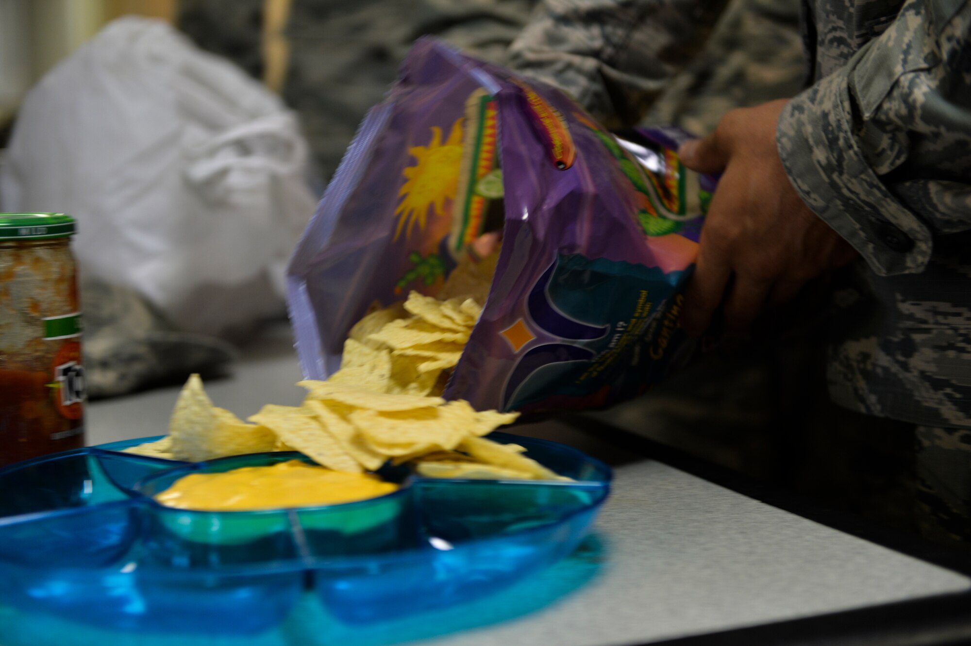 Tortilla chips are spread onto a plate for a diversity lunch at the Airman Leadership School house on Hurlburt Field, Fla., Aug. 5, 2014. The students are encouraged to bring a dish that represents their ethnic background. (U.S. Air Force photo/Senior Airman Christopher Callaway) 