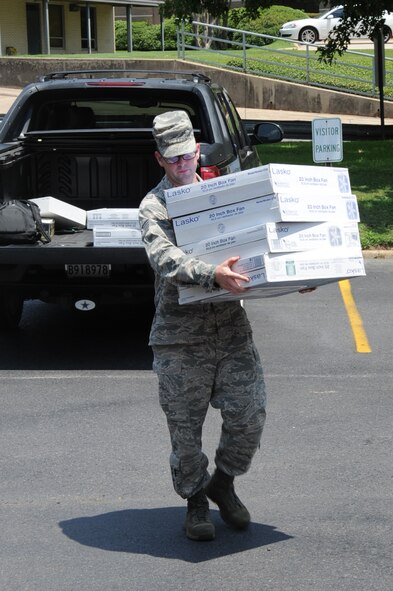 Tech. Sgt. Matthew Warner, 2nd Maintenance Group quality insurance inspector, delivers fans to KSLA News 12 as part of Operation Beat the Heat in Shreveport, La., Aug. 8, 2014. Operation Beat the Heat, hosted by the Caddo Counsel on Aging, provide fans to elderly people in the surrounding area who may not have air conditioning or cooling units. (U.S. Air Force photo/Staff Sgt. Sean Martin)