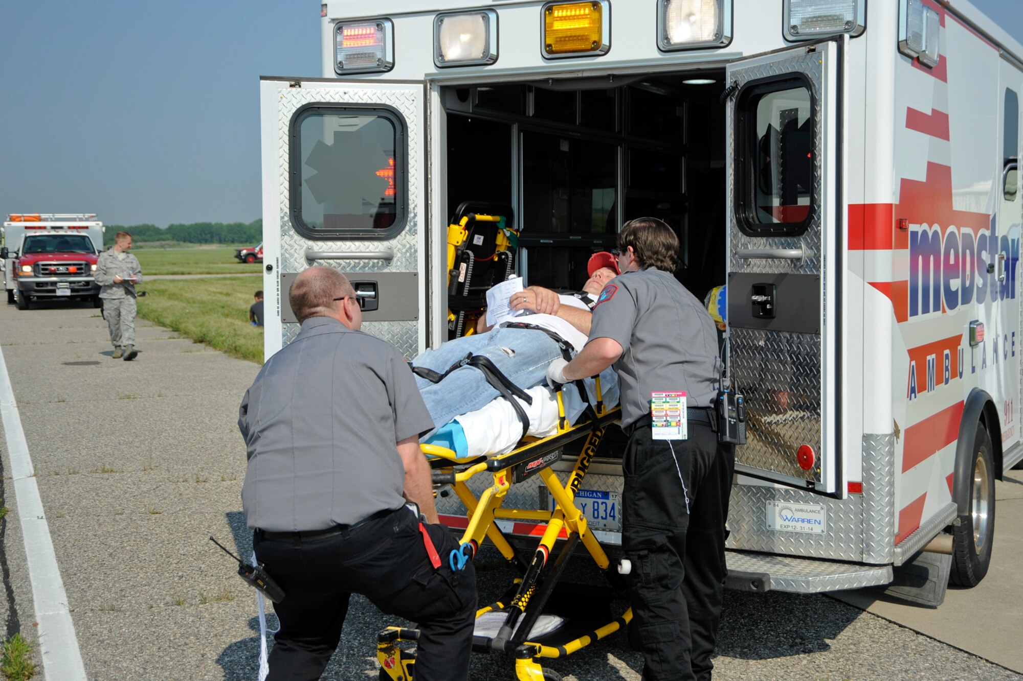MedStar Ambulance responds to mock vicitms during a major accident response exericse held at Selfridge Air National Guard Base on July 22, 2014.  The exercise scenario included an airplane crash with multiple injuries on the ground and showed how an incident can get complex quickly.  Selfridge holds annual MARE scenarios annually to test and enhance the readiness capabilities of the unit. (US Air National Guard photo by Terry L. Atwell)

