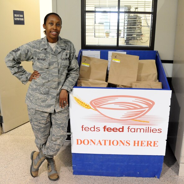 Tech. Sgt. Tanisha McKnight, 341st Medical Operations Squadron dental clinic NCO in charge, stands next to the donation box in the front of the Malmstrom Air Force Base Commissary. McKnight is one of Malmstrom’s points of contact for the 2014 Feds Feed Families campaign. The Feds Feed Families campaign is a federal campaign in which volunteers gather items to help families who are struggling with poverty. (U.S. Air Force photo/Airman 1st Class Joshua Smoot)